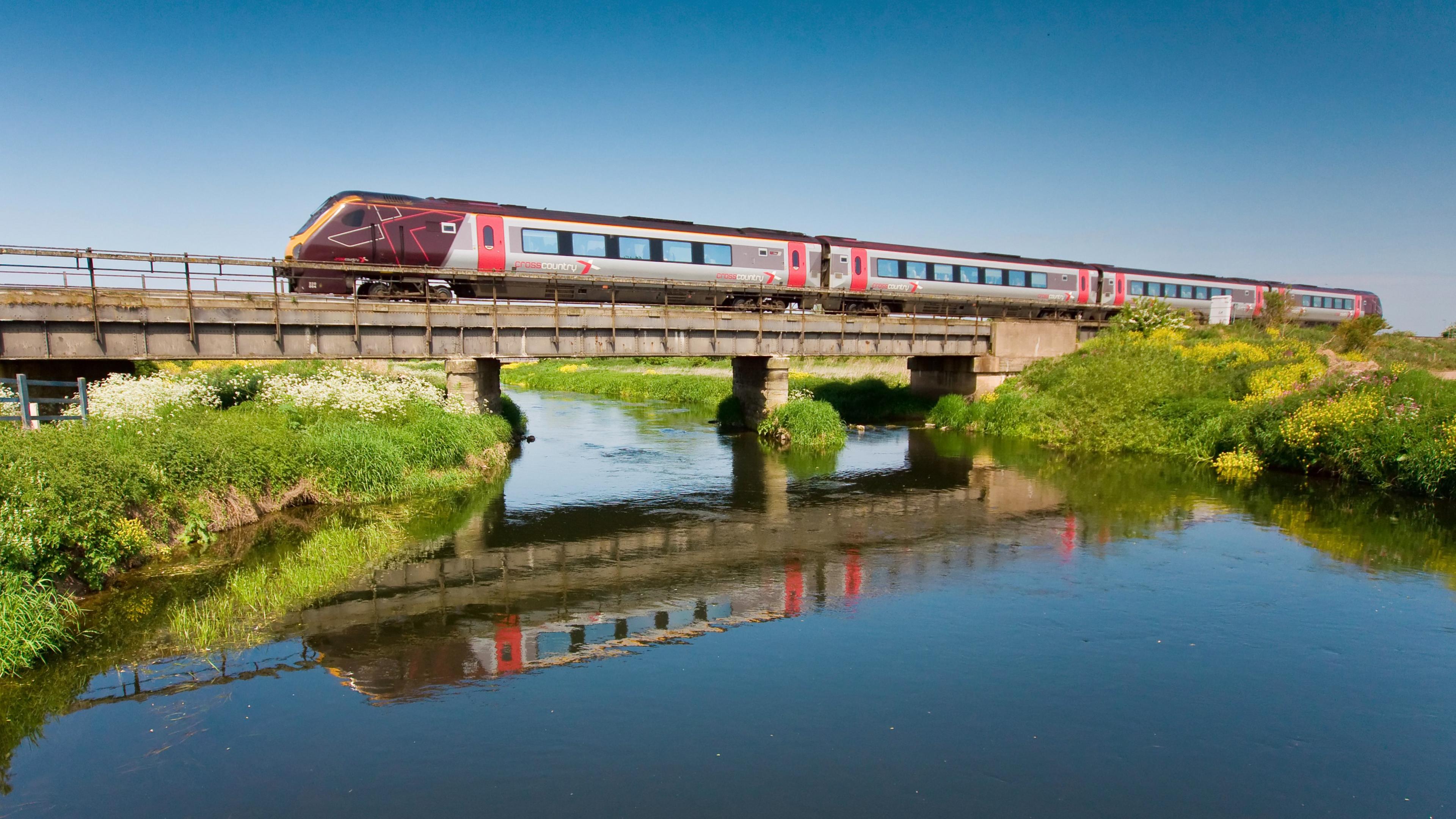 A CrossCountry train travelling on a bridge over a river