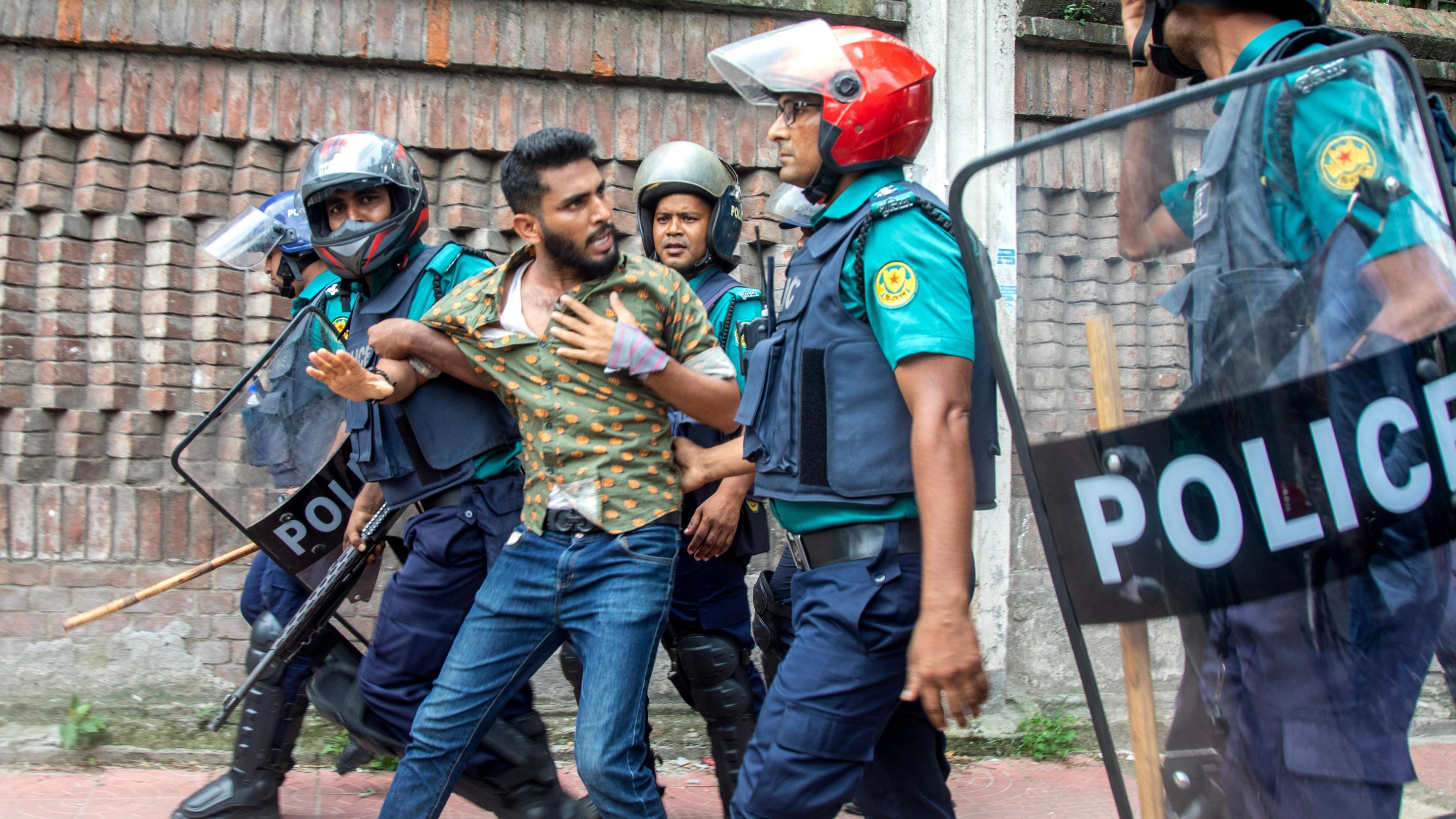 Bangladeshi police detain a protester during a demonstration in front of the Supreme Court in Dhaka, Bangladesh, on 31 July.