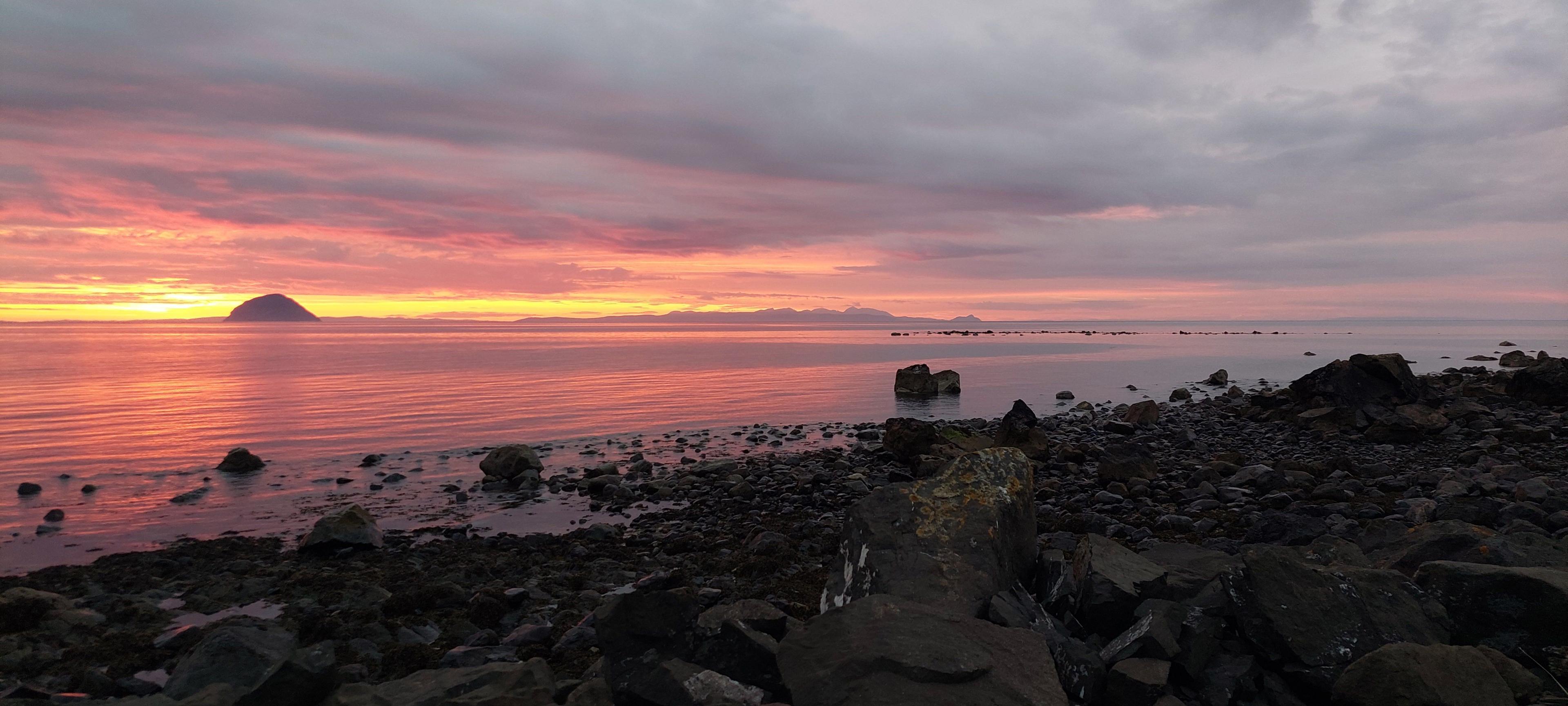 Landscape image of a beach at sunset