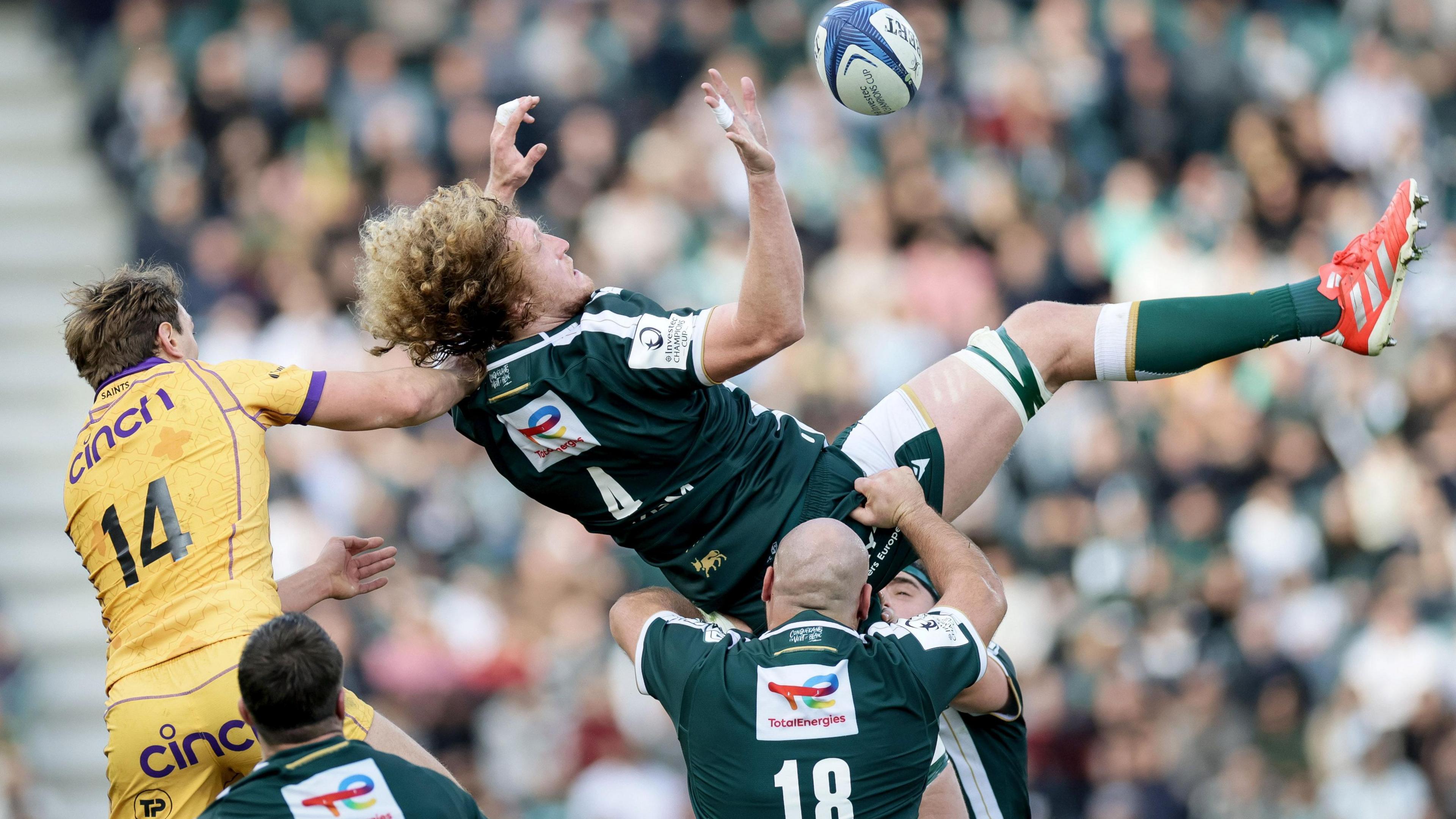 Thomas Jolmes of Pau and Northampton Saints' James Ramm compete for a ball in the air