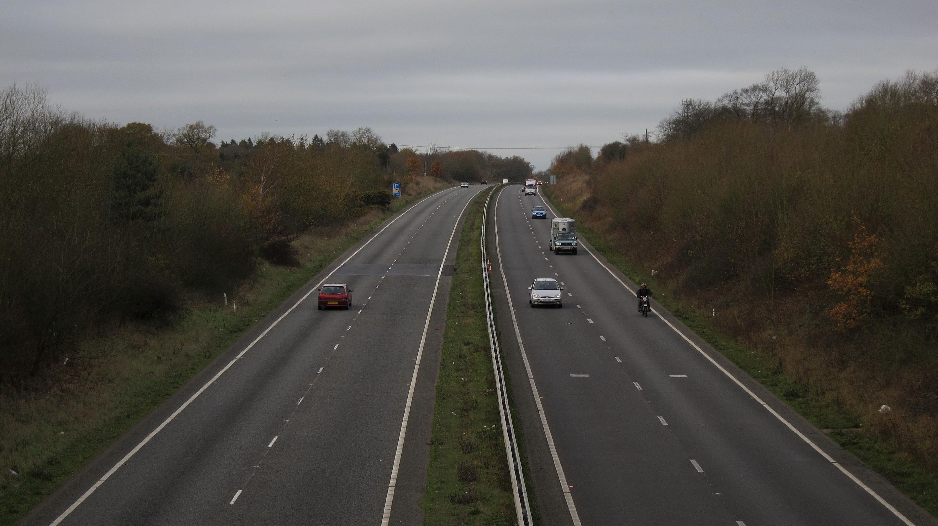 A motorcyclists rides on a dual carriageway