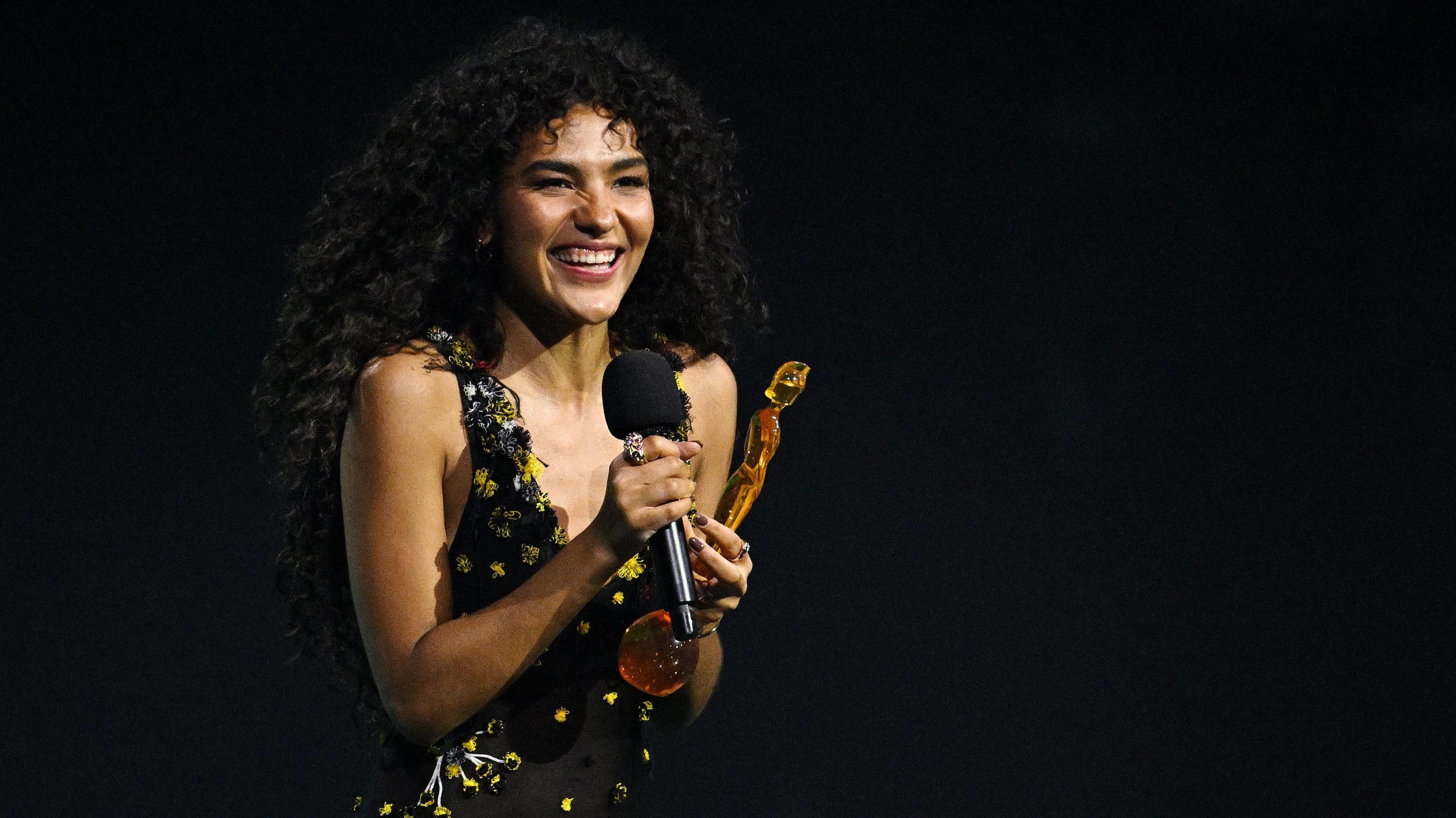 Olivia Dean receives the artist of the year award during the Brit Awards 2026 at Co-op Live.