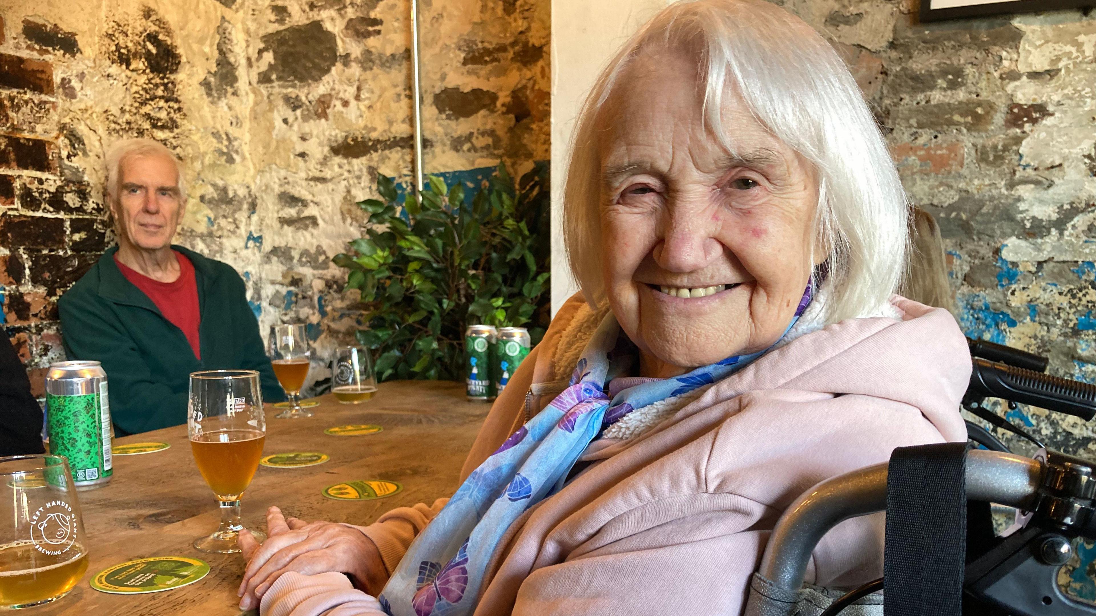 Sylvia Crowther looking at the camera, sat in front of a glass of beer