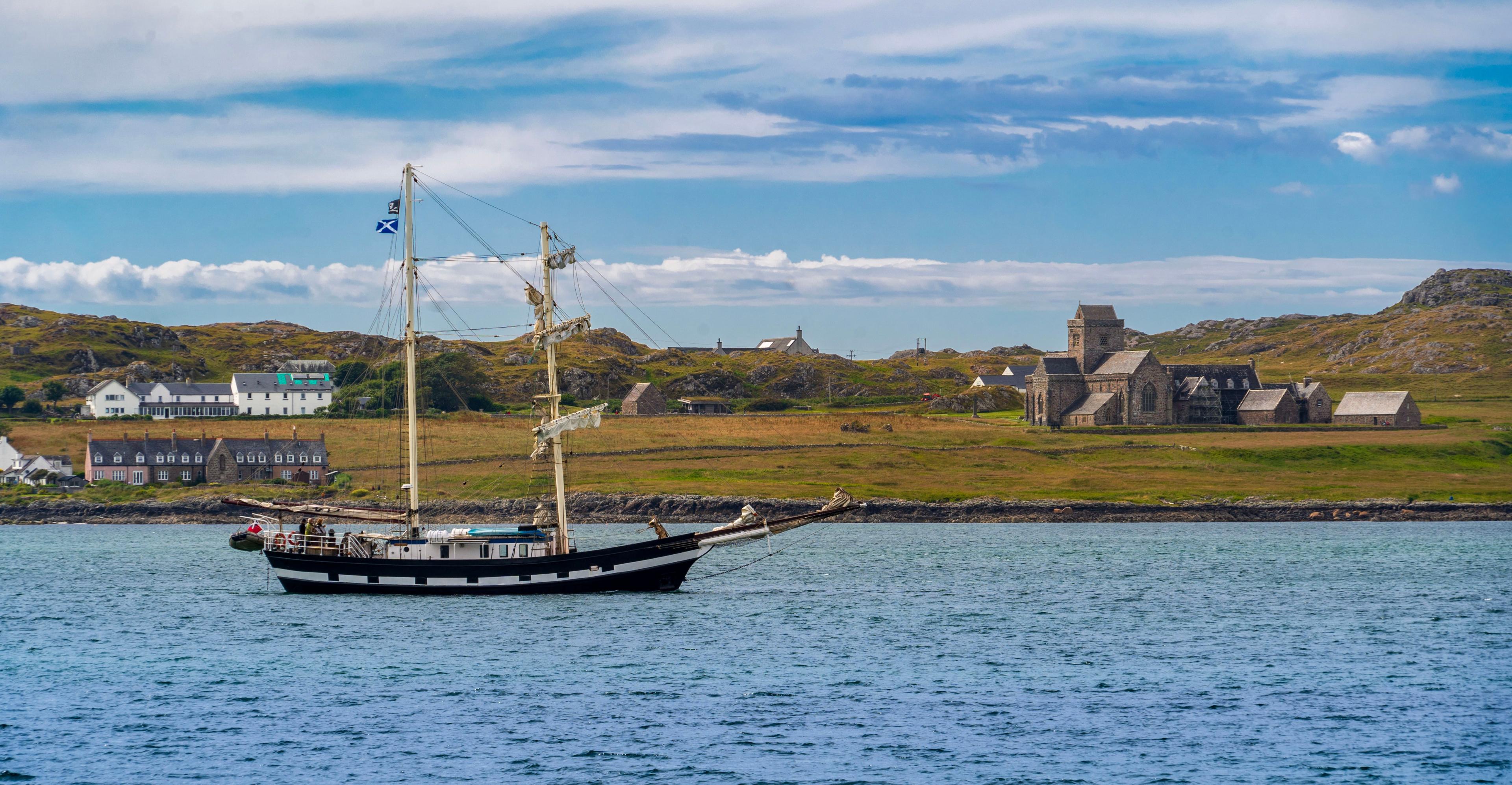 Boat sailing past an island with a church