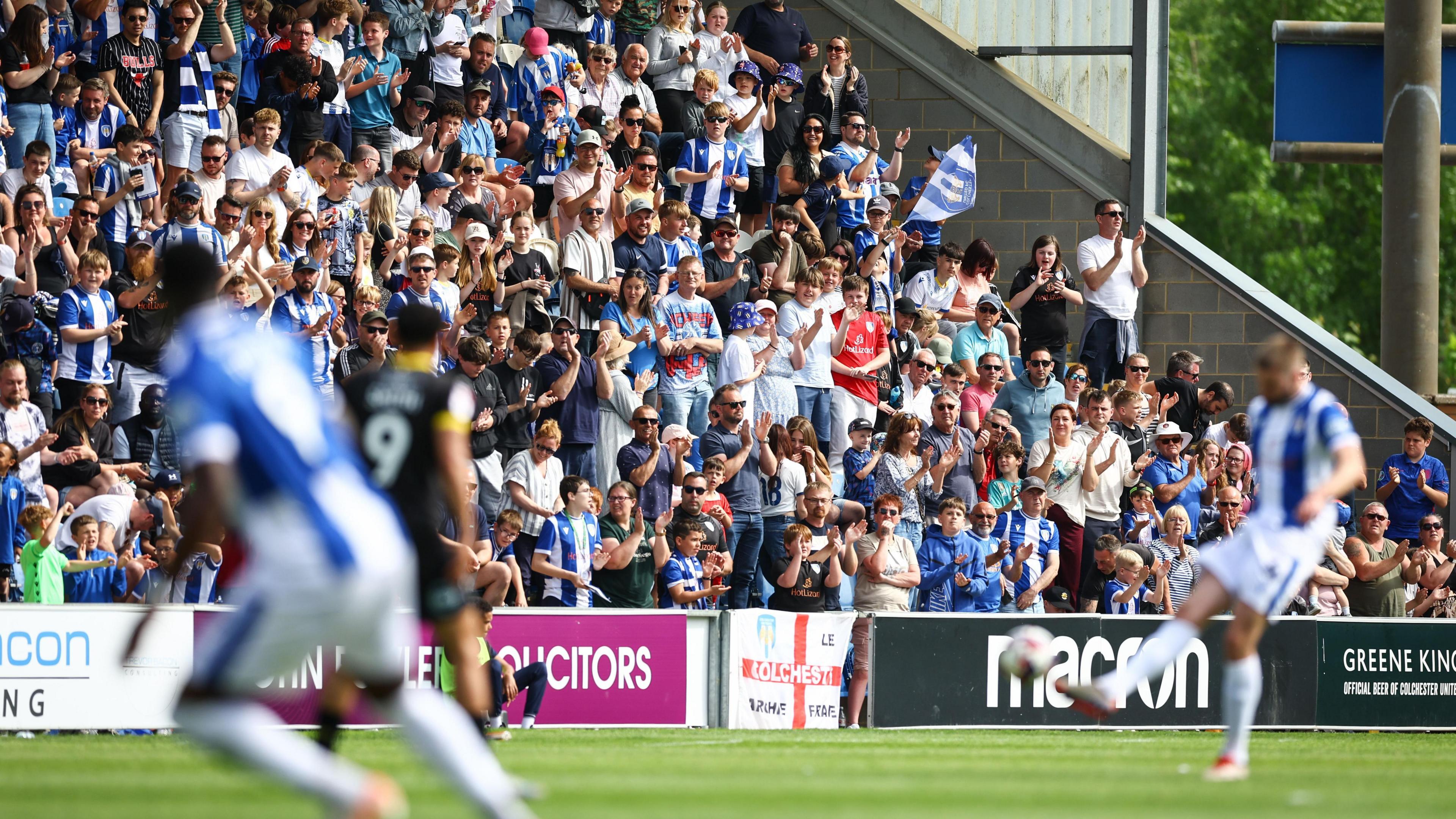 Colchester fans watch on from the stands during the Us final day 0-0 draw against Barrow