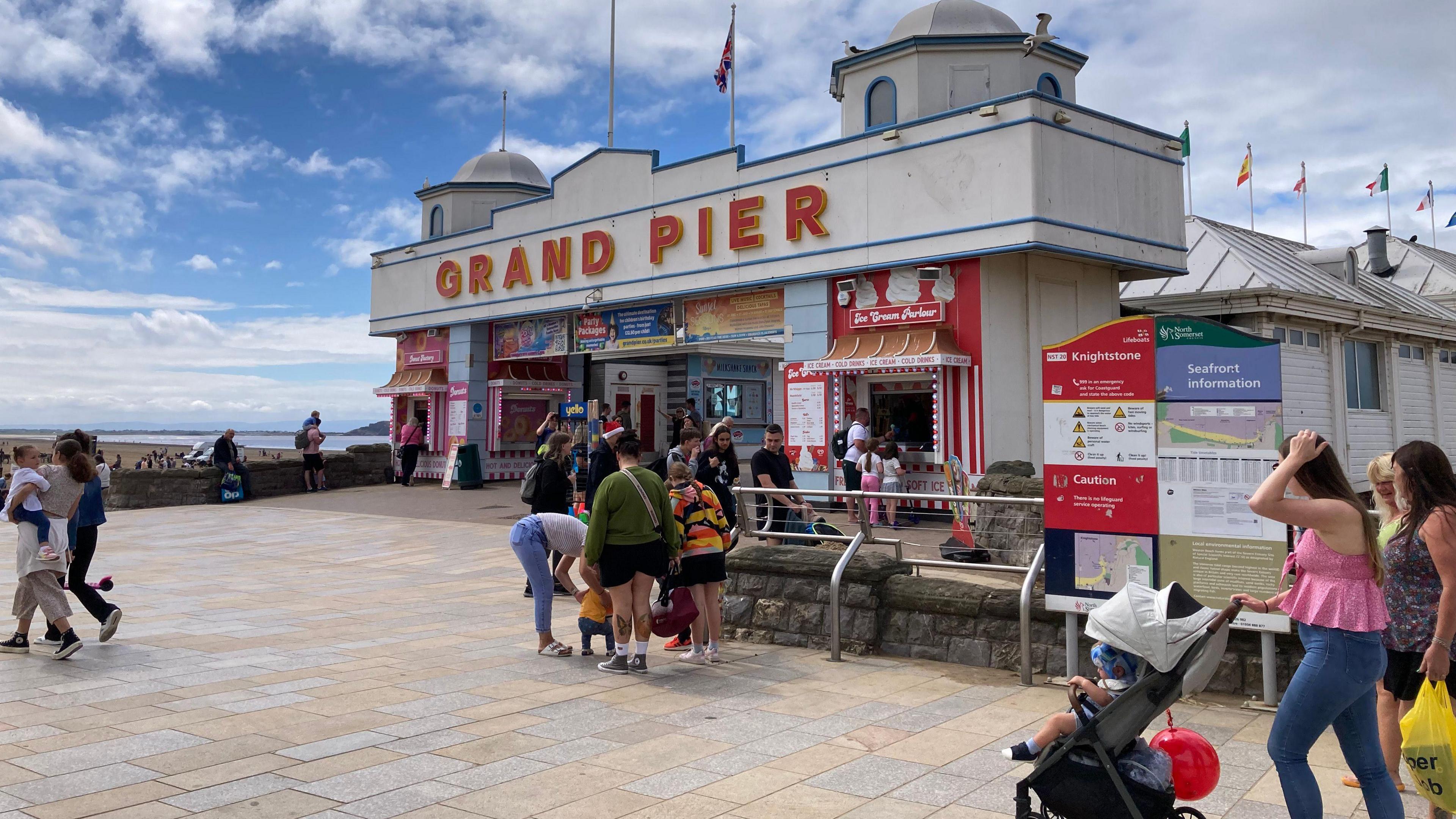 Families walking around the entrance to the Grand Pier in Weston-super-Mare