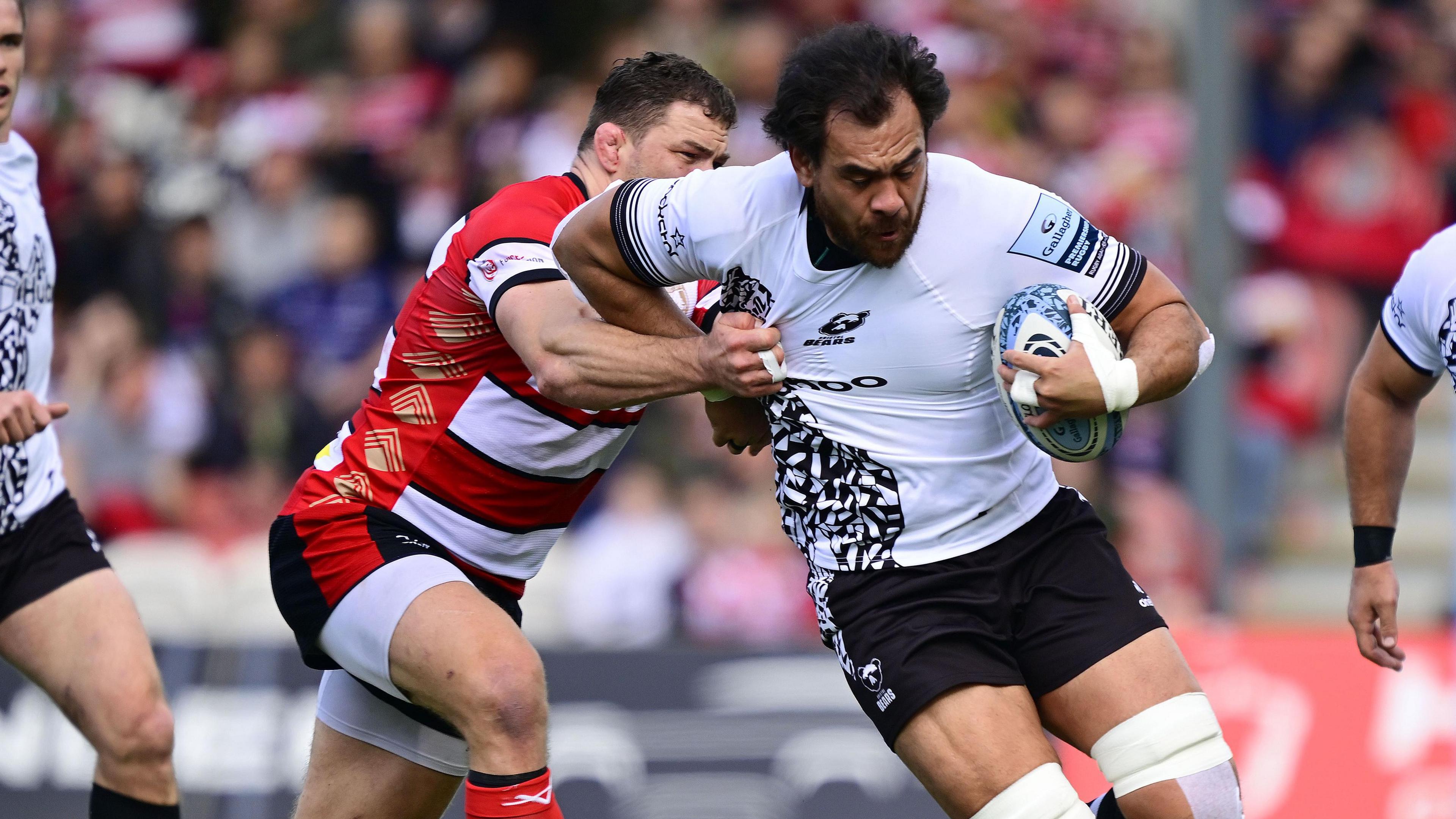 Steven Luatua holds off a defender during a game