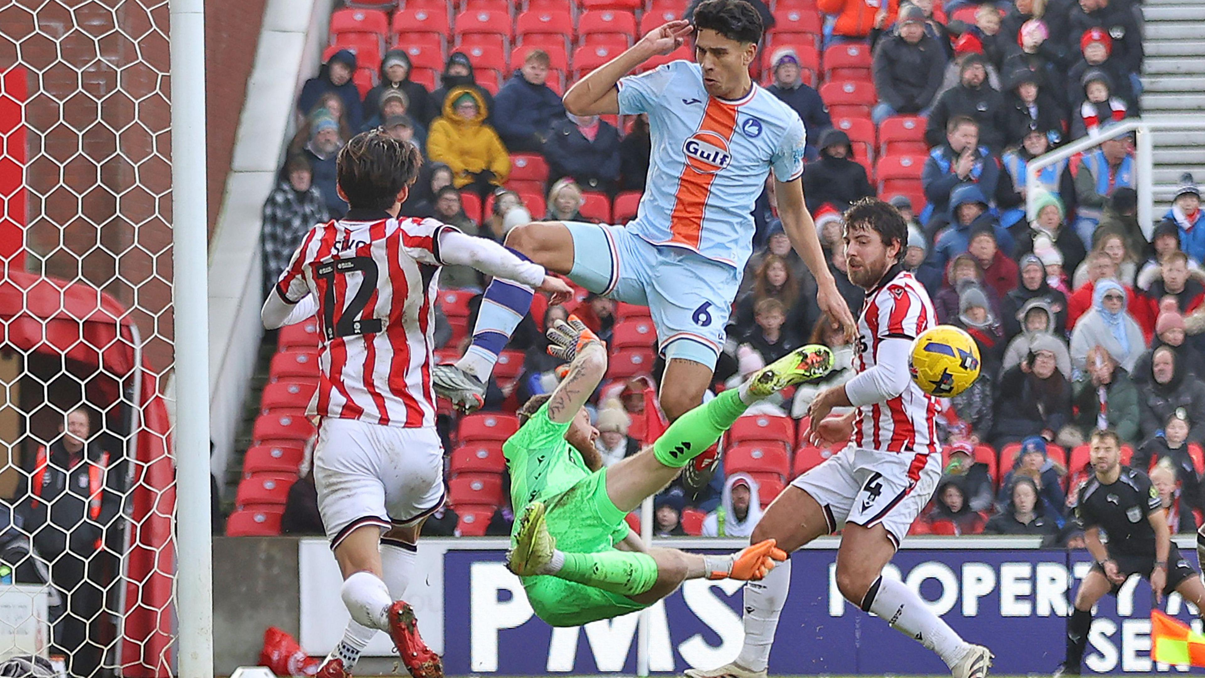 Stoke goalkeeper Viktor Johansson denies Marko Stamenic