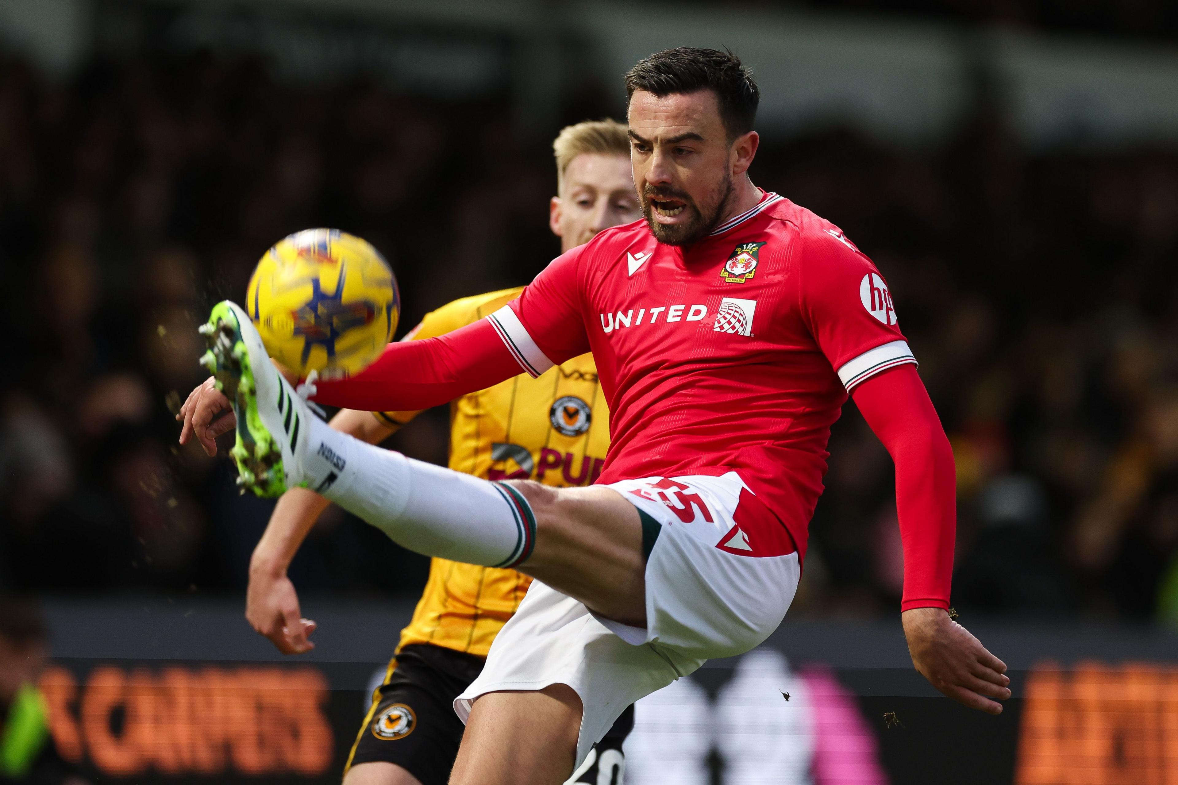 Eoghan O’Connell  clears the ball away for Wrexham                                                