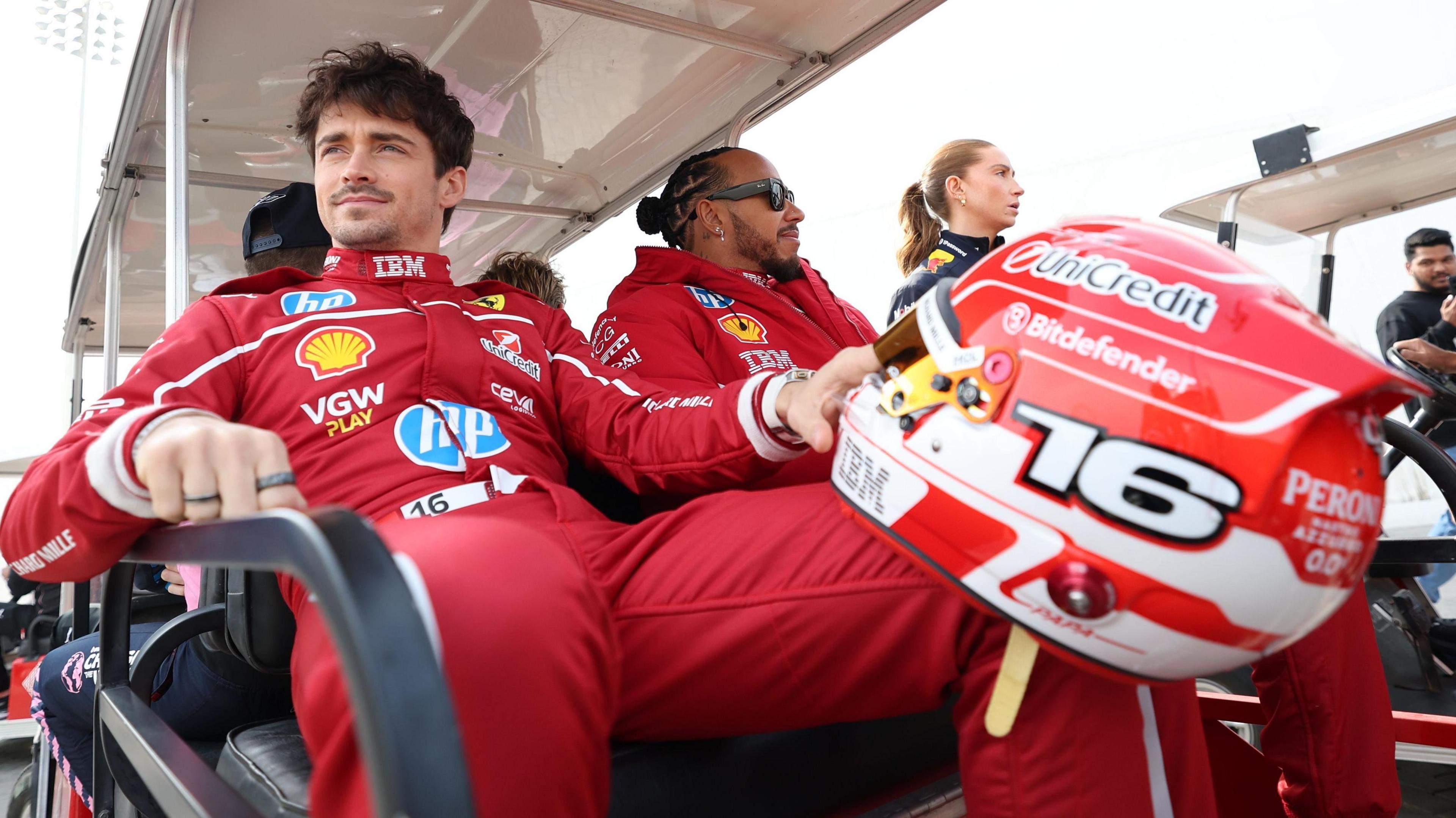 Charles Leclerc sat to the near  and holding his F1 clang  helmet with Lewis Hamilton instantly  to his right