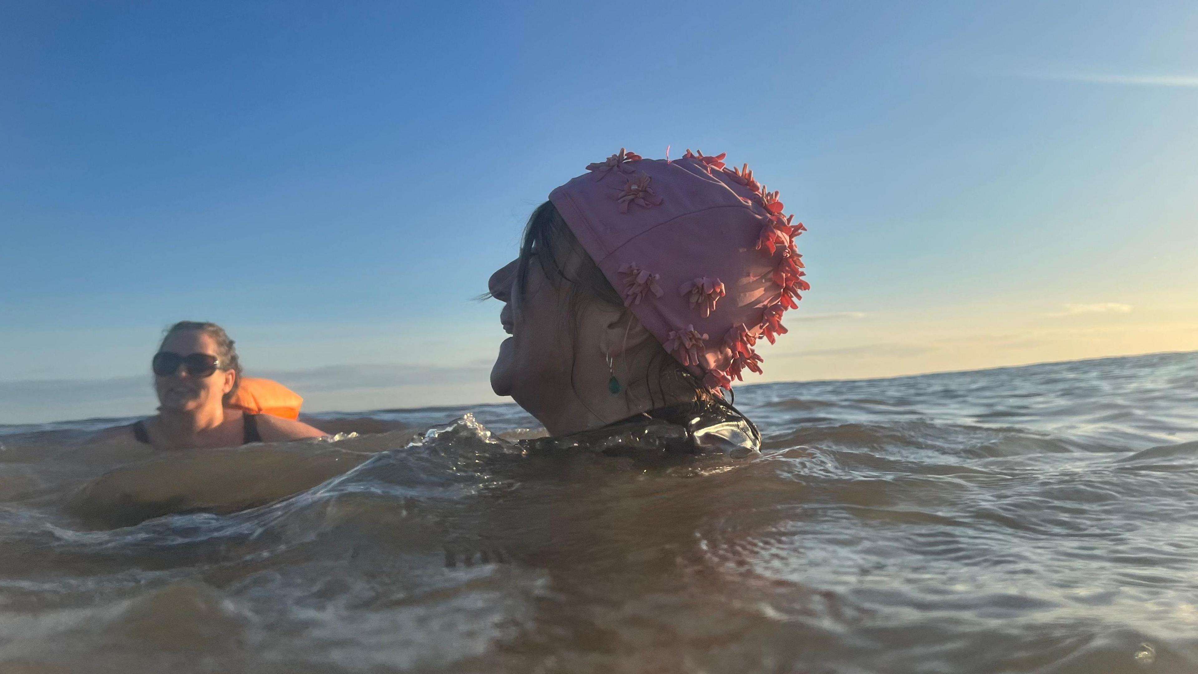 Kate, wearing sunglasses, and Angie in her flowery pink swimming hat are members of the Hornsea Mermaids and are enjoying a dip in the North Sea 