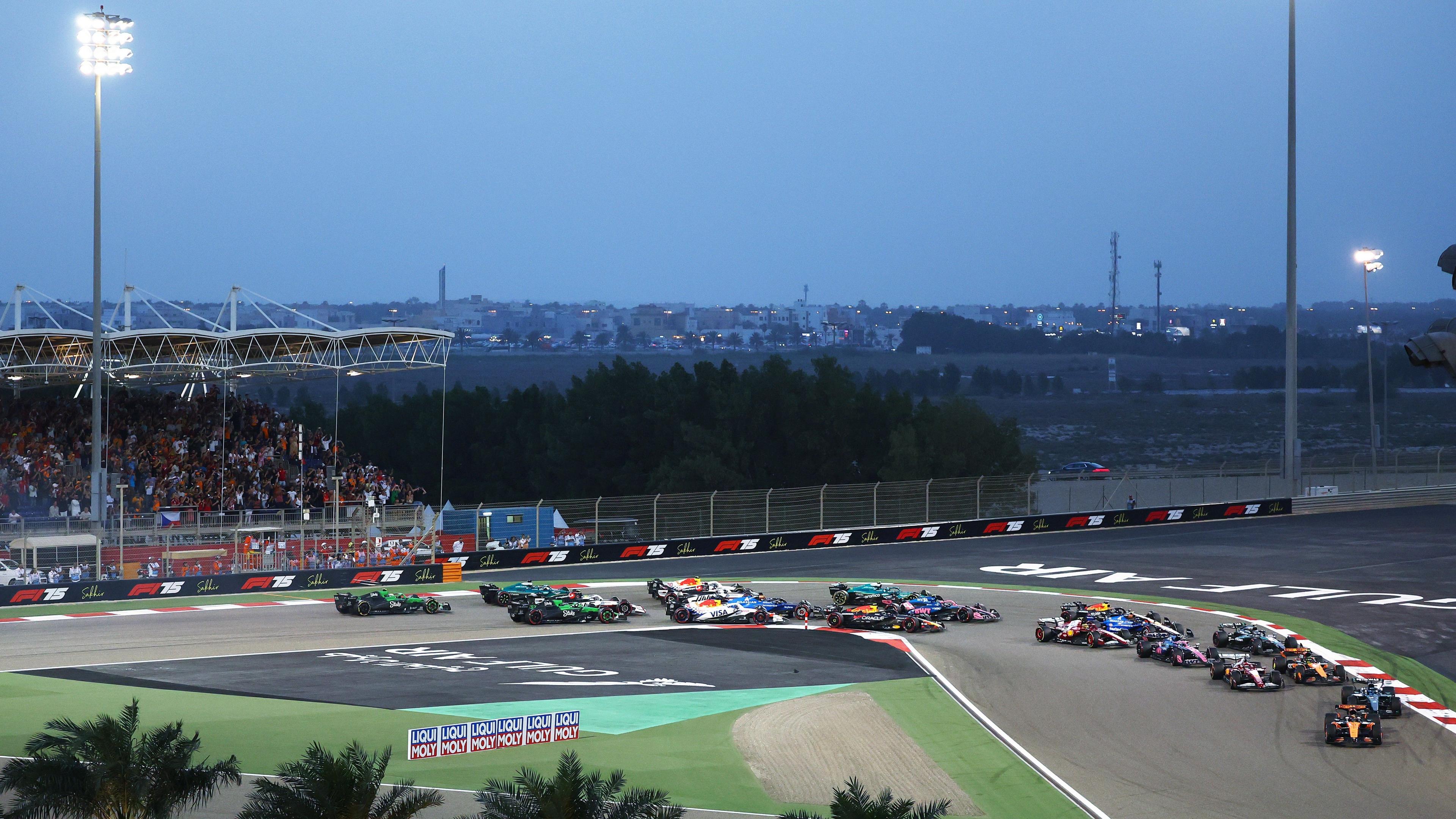 F1 cars race through first corner of Sakhir circuit in Bahrain