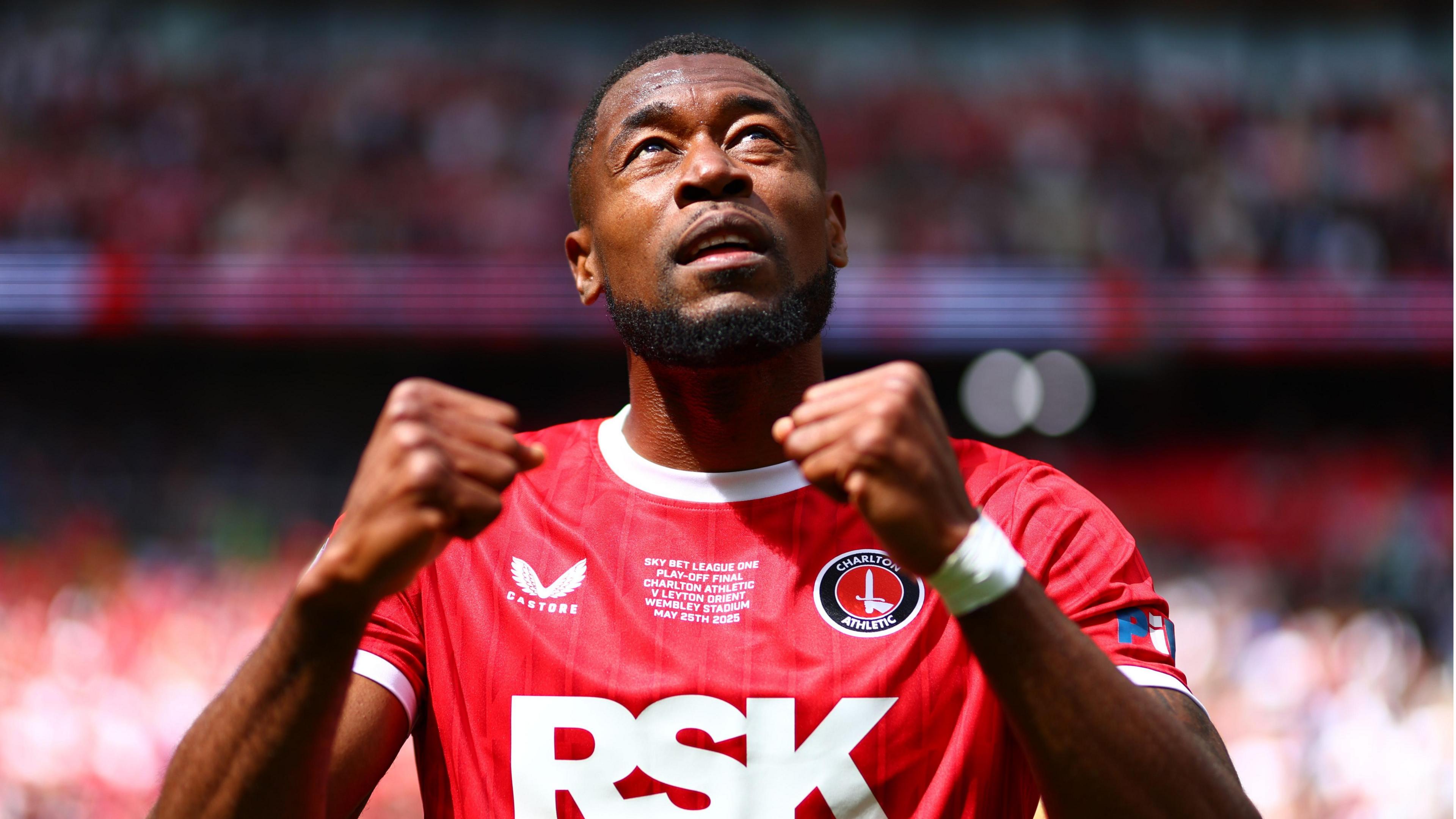 Chuks Aneke pumps both fists and looks to the sky in celebration after Charlton's victory in the League One play-off final at Wembley