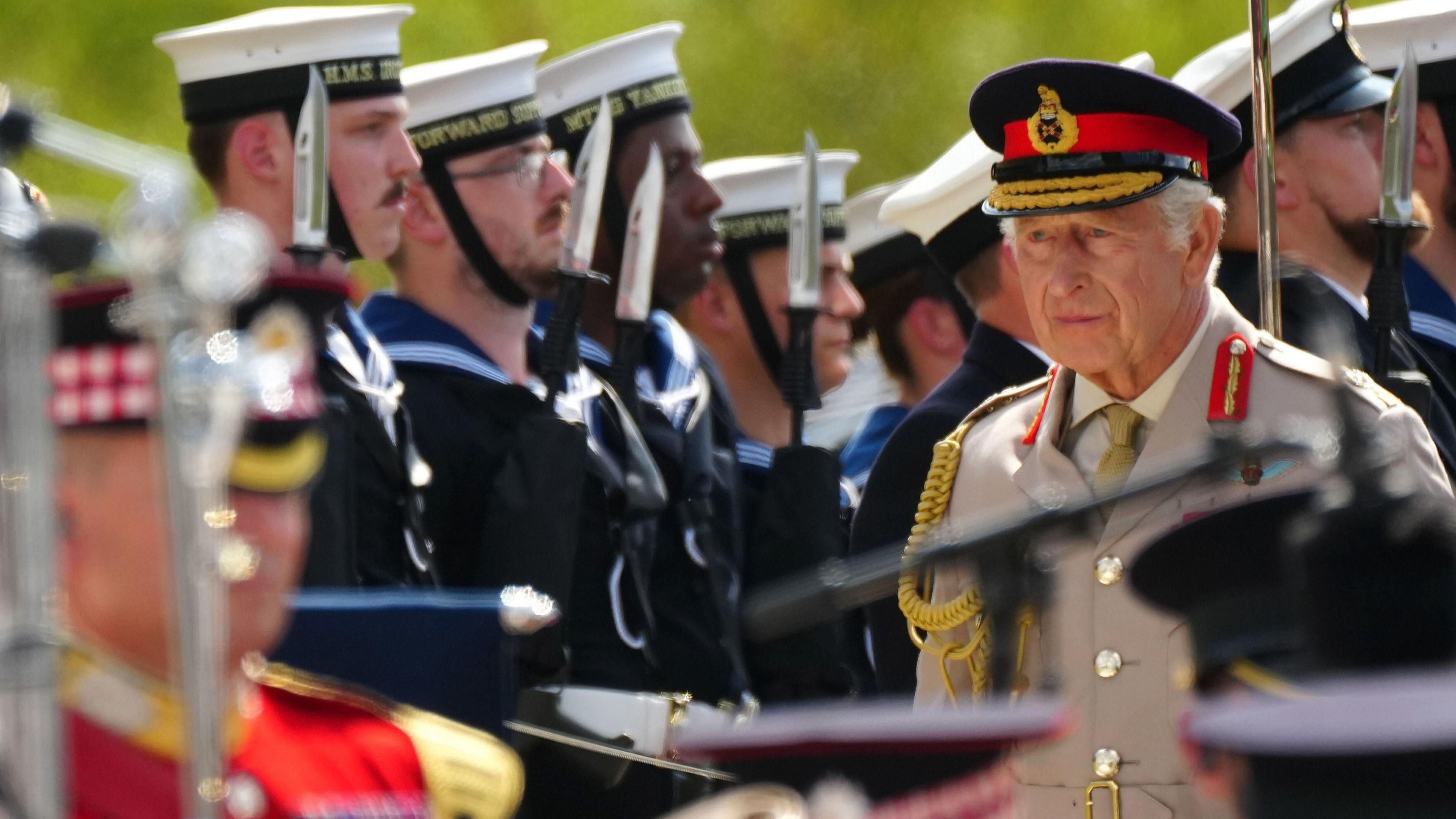 King Charles walks amid members of the UK's armed forces