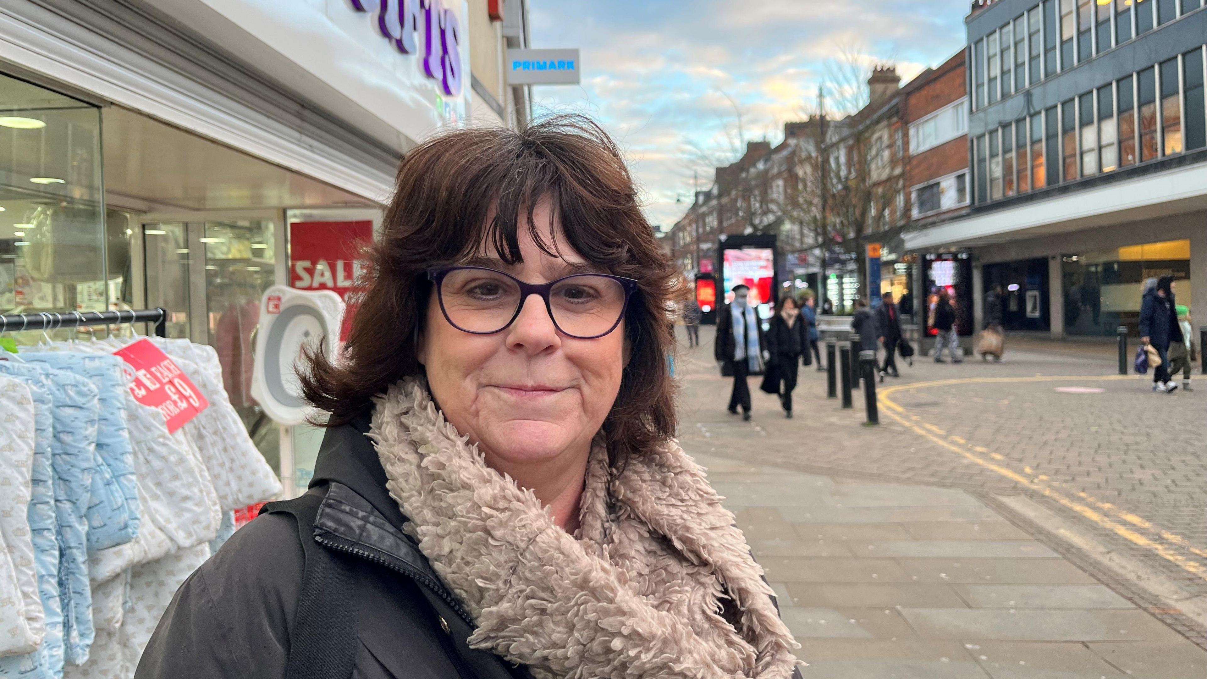 Linda looking at the camera on a shopping street in Romford