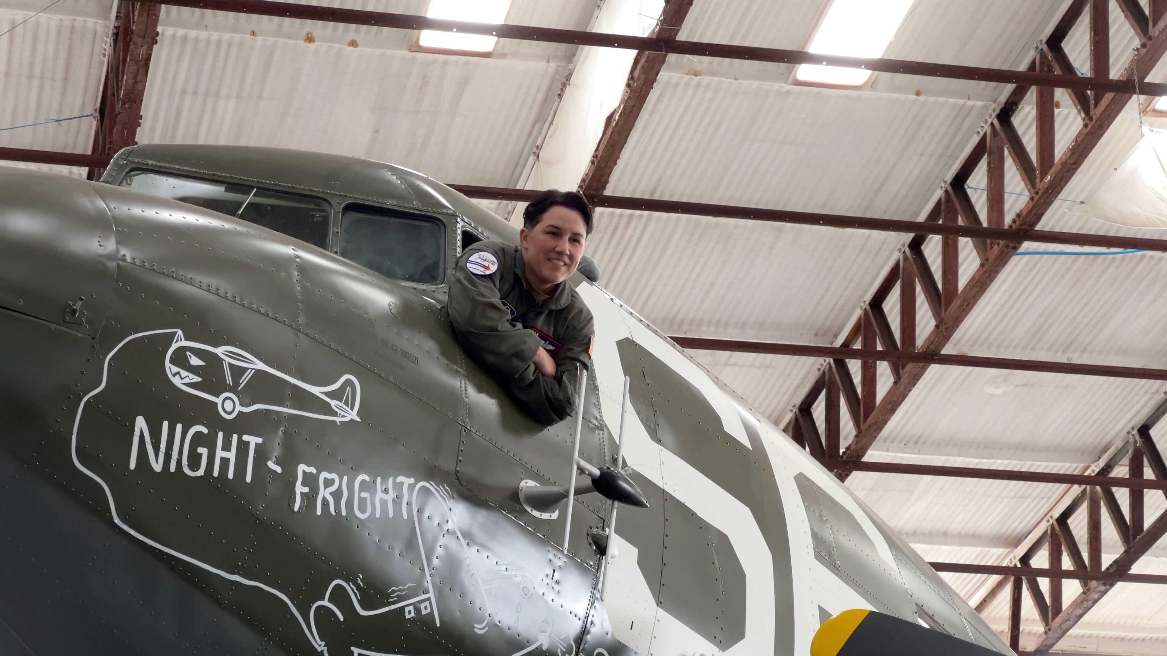One of the US air crew leans out of the plane's cockpit window to have her photograph taken.