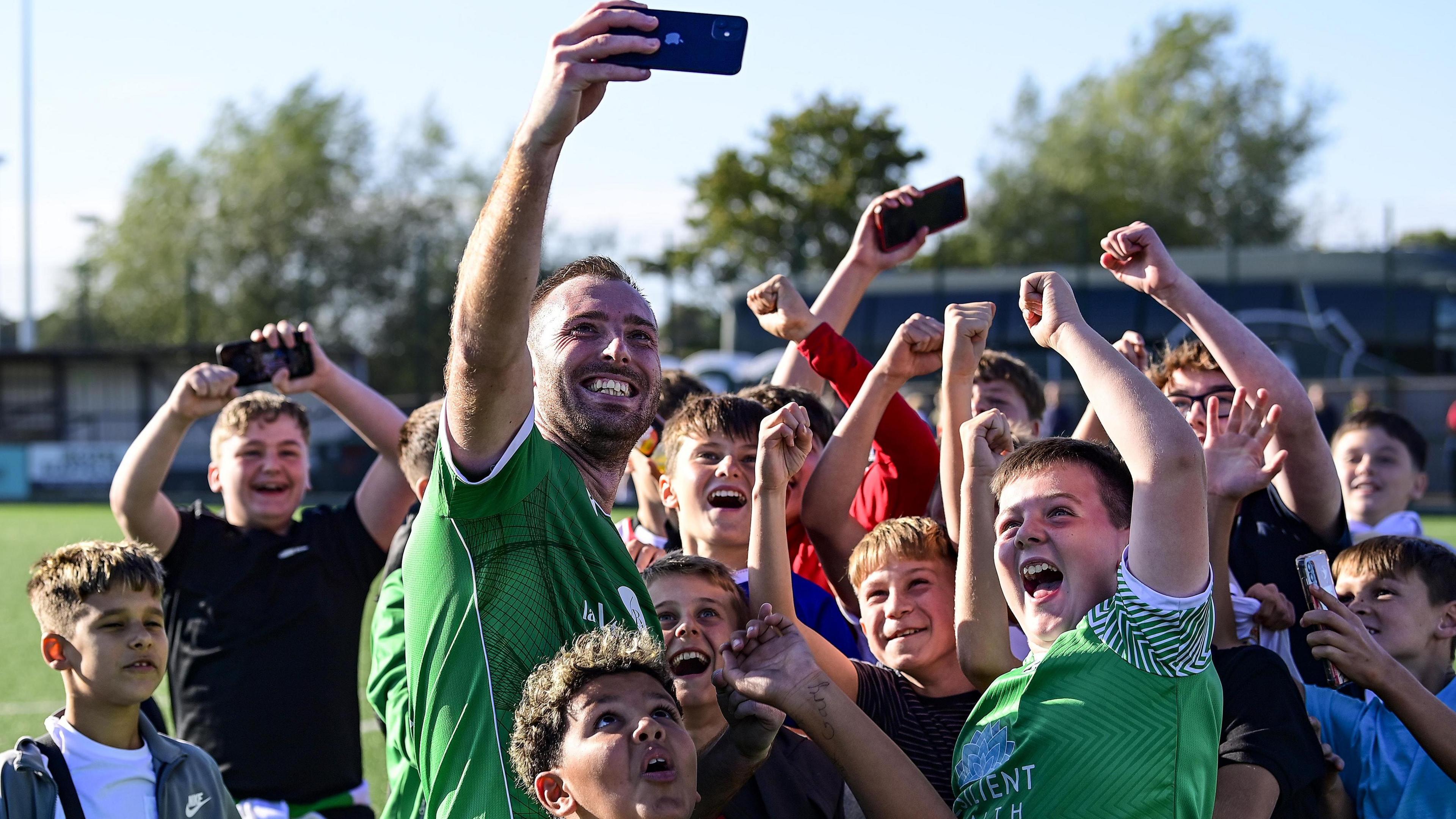 Goalscorer Ross Langworthy poses with fans