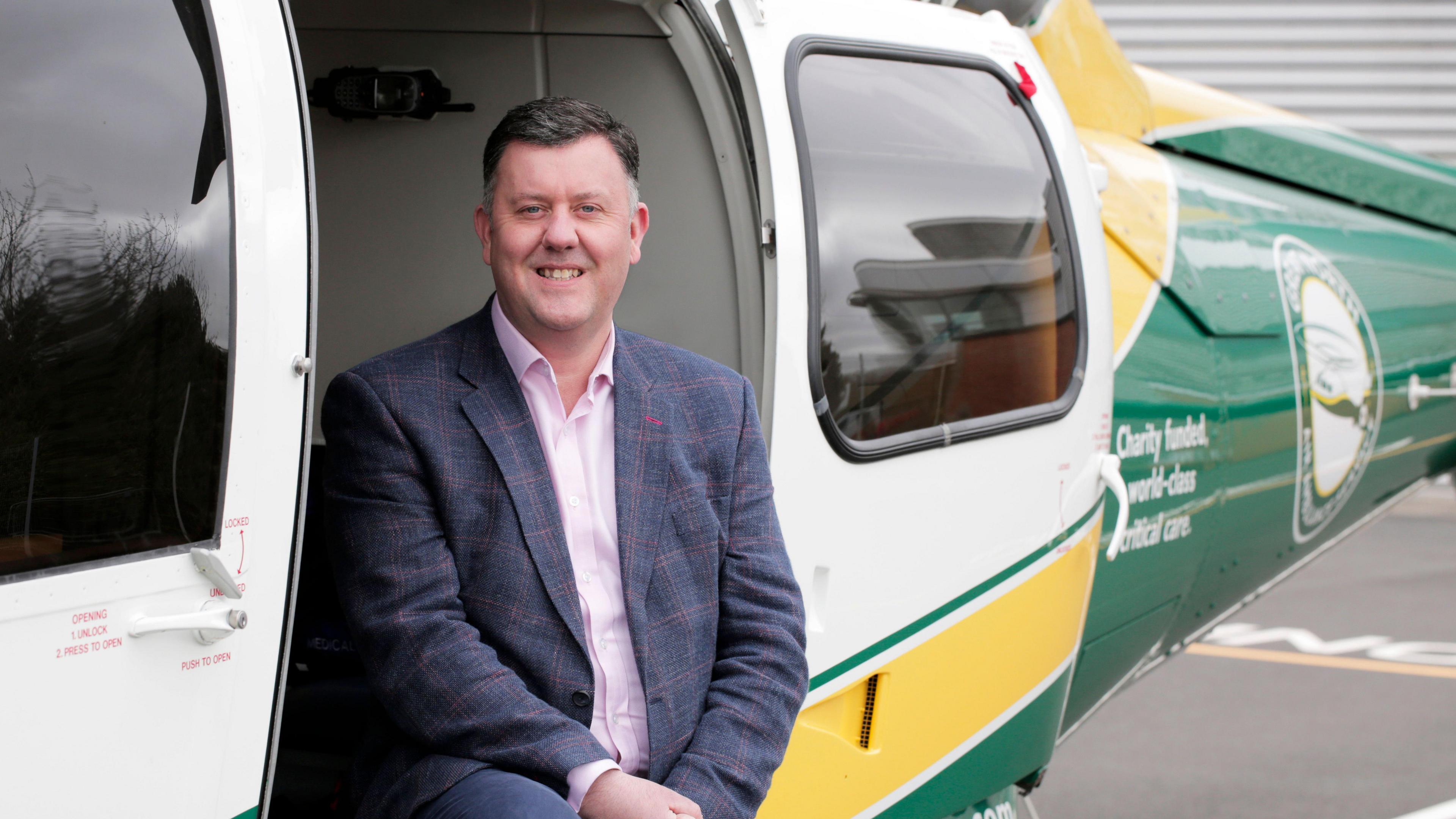 GNAAS chief executive David Stockton sitting in a helicopter