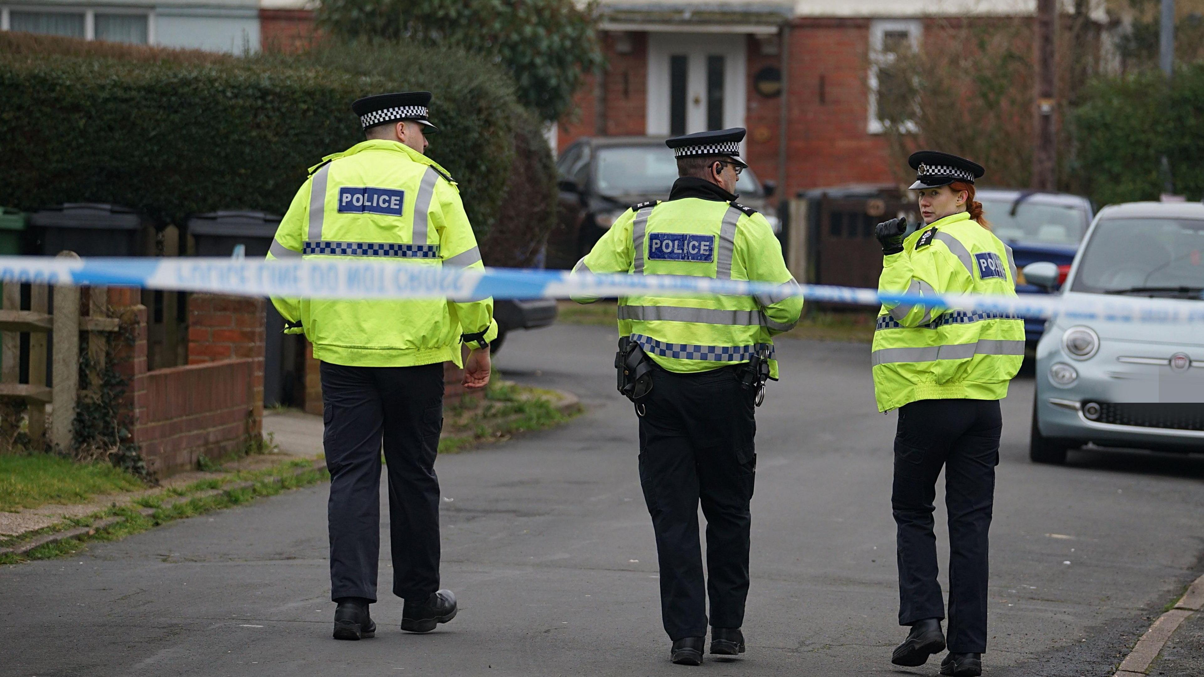 Several police officers investigating an incident.