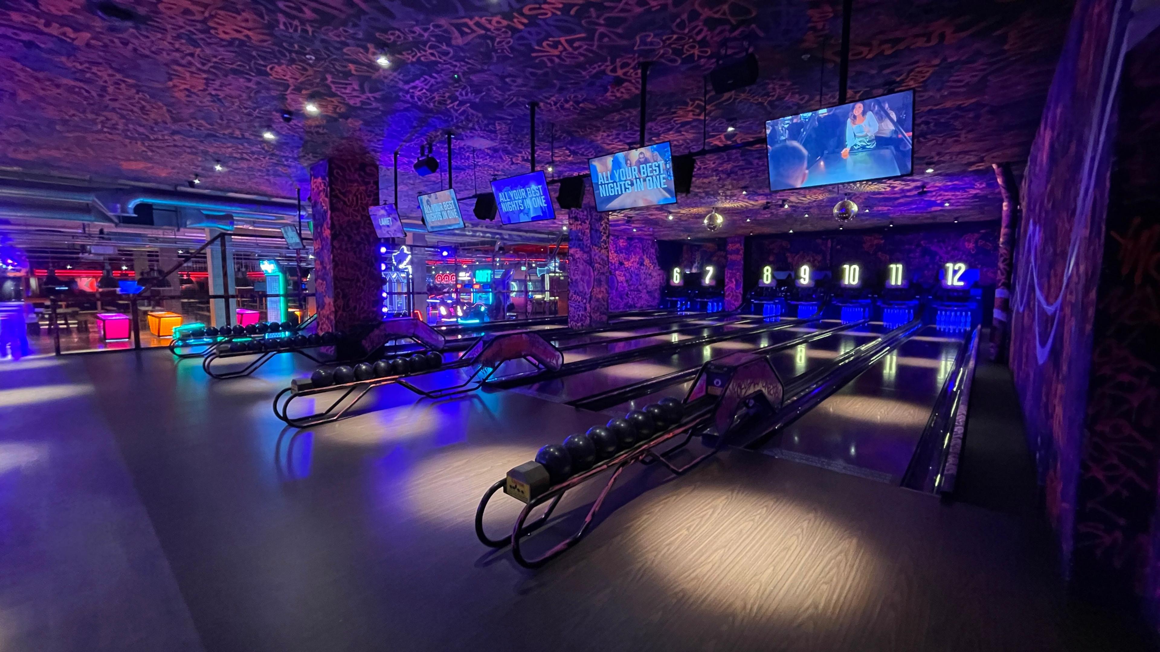 The interior of Lane 7 showing a bowling alley under UV lighting.