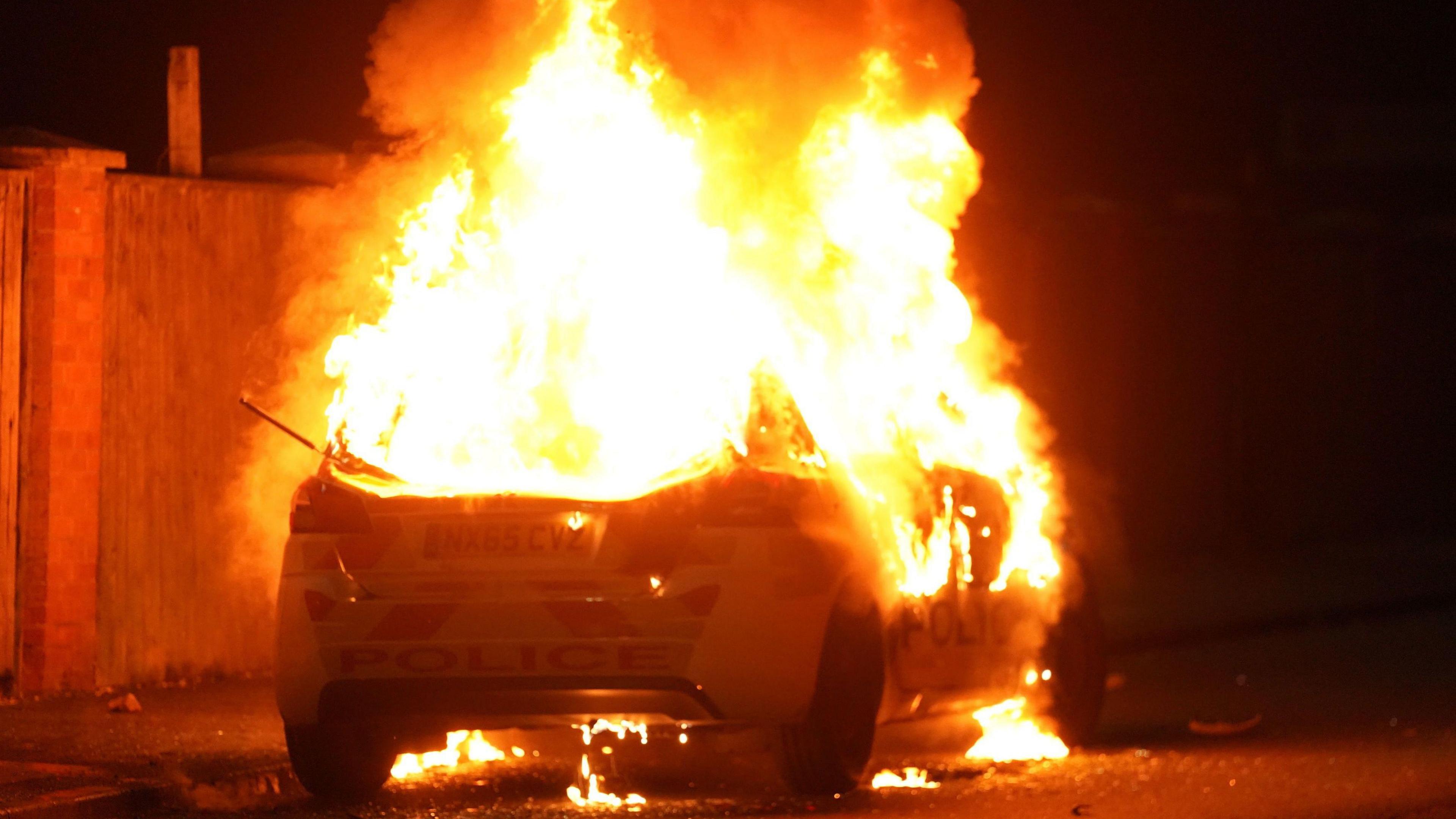 A police car ablaze during the Hartlepool protests