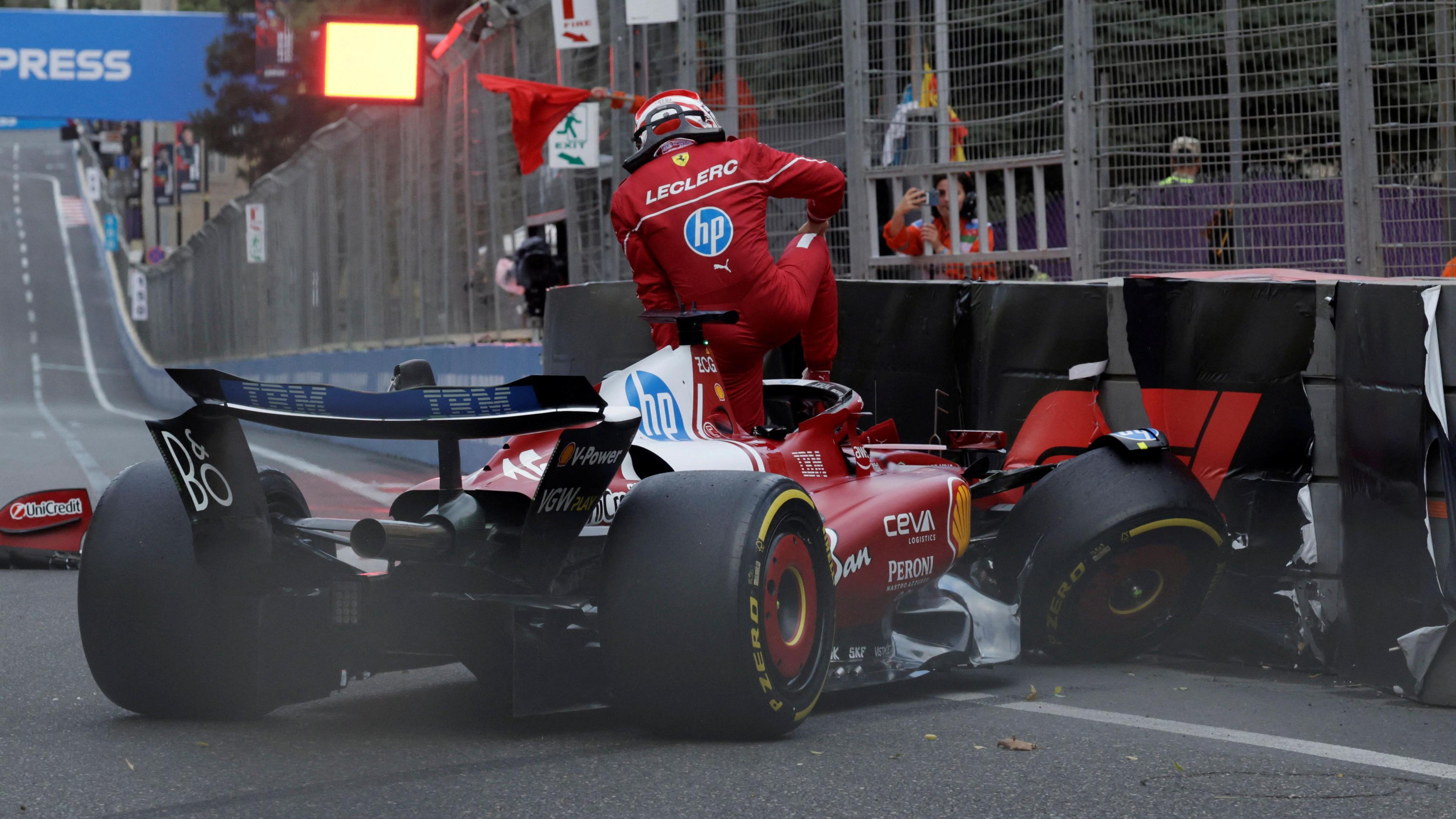 Ferrari's Charles Leclerc climbs out of his car after crashing into the barriers during qualifying for the Azerbaijan Grand Prix