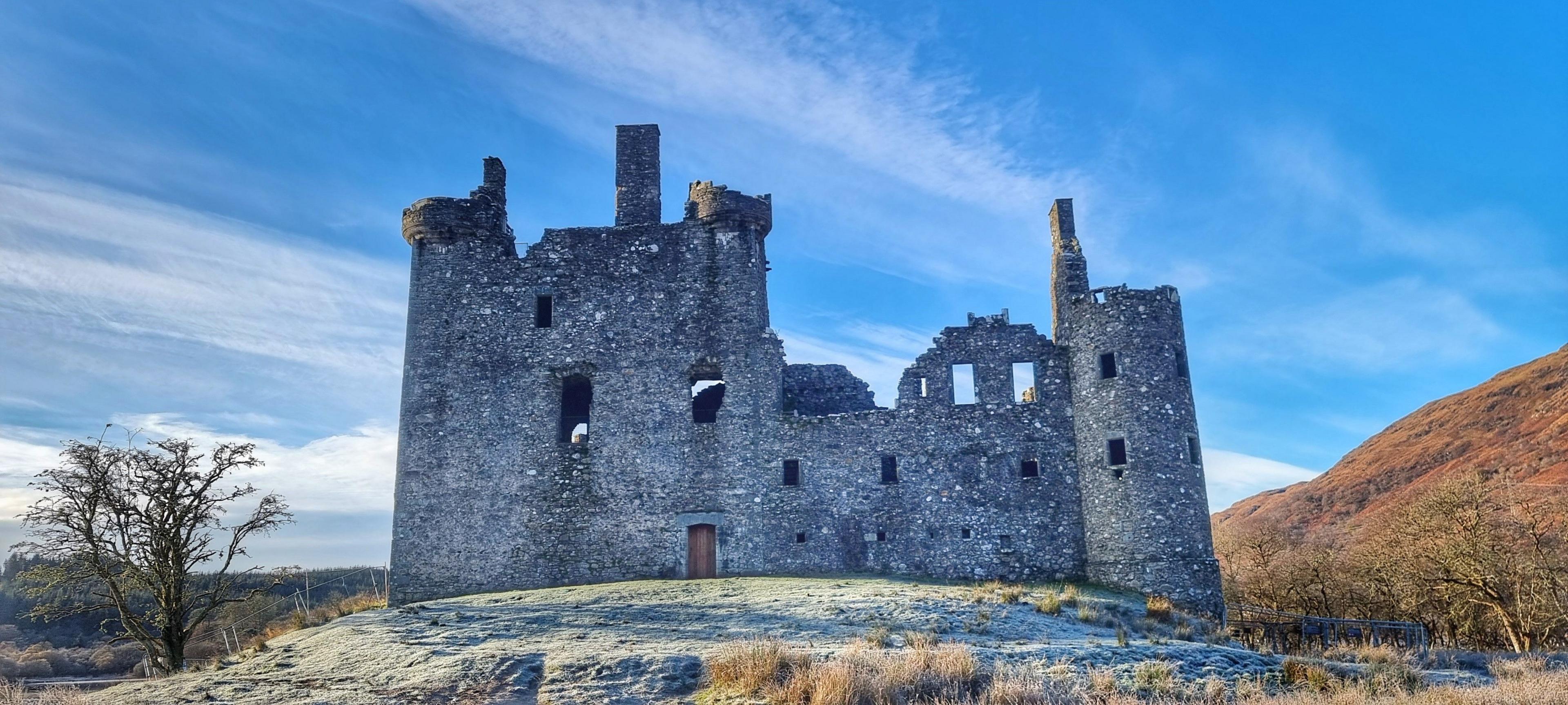 A ruined castle cuts a fine outline on a chilly day with a clear blue sky