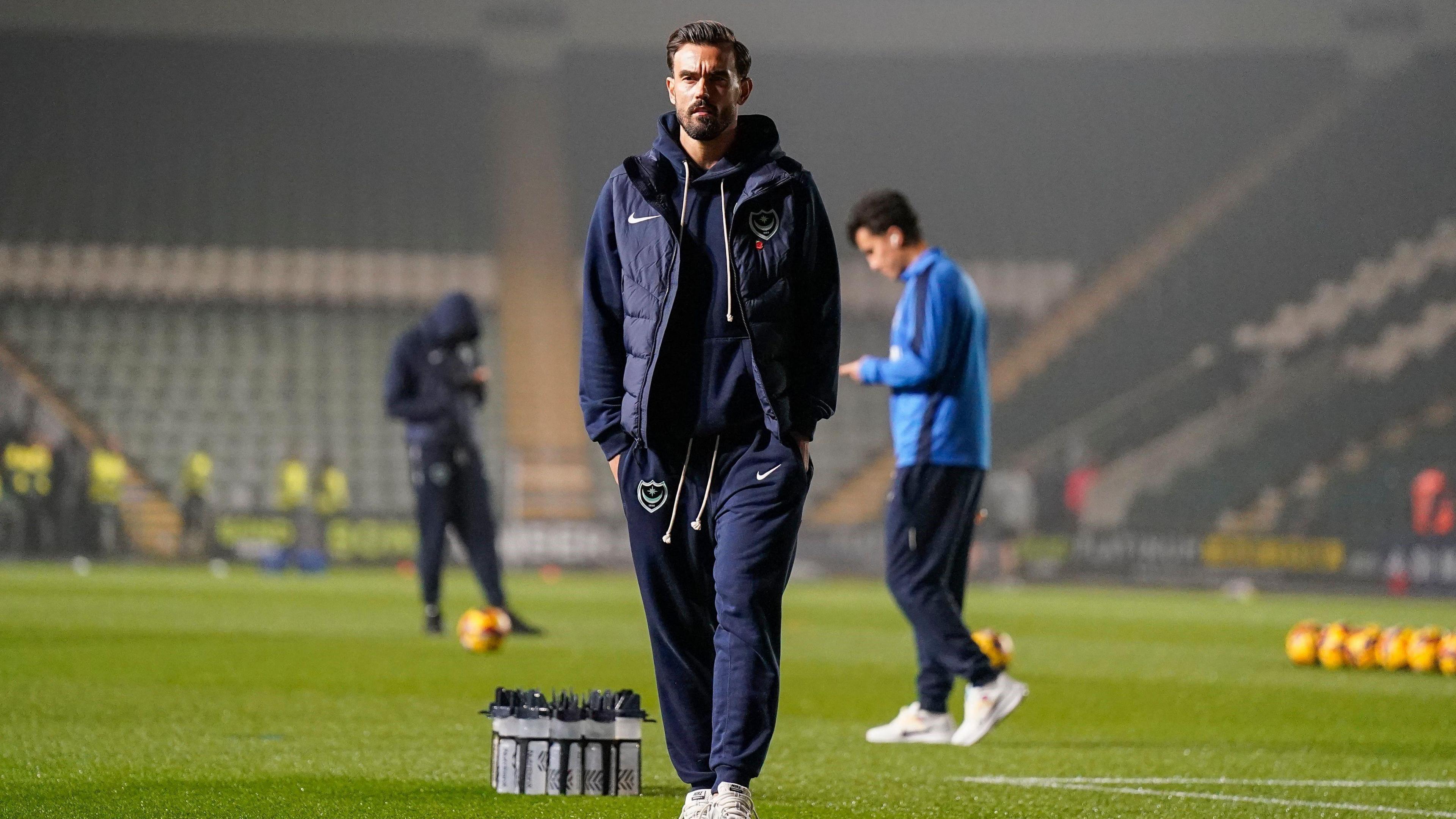 Portsmouth captain Marlon Pack stares into the distance as he wanders off the pitch at Home Park ahead of Plymouth Argyle against Portsmouth in the Championship