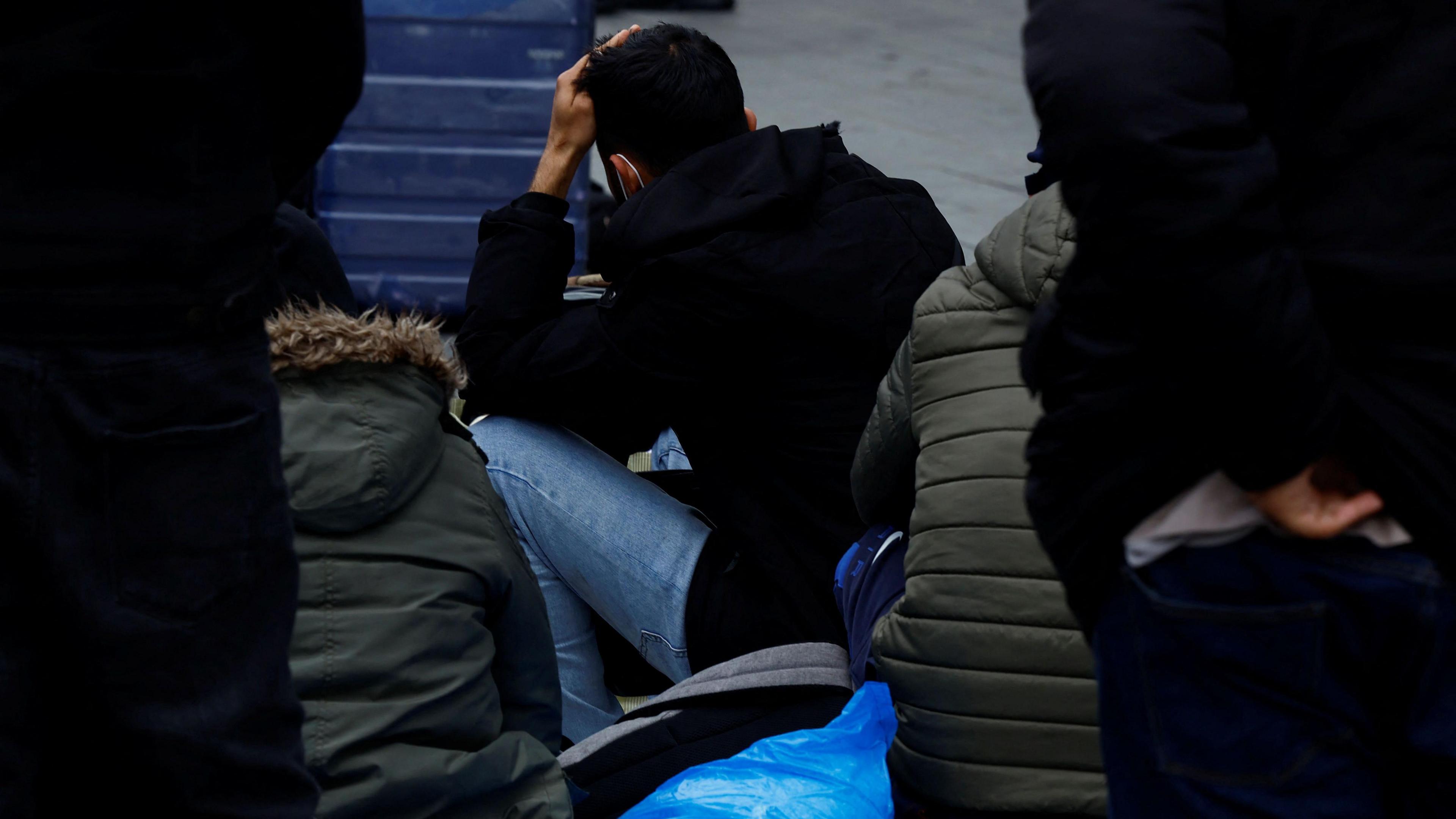 An aslyum seeker sits outside the International Protection Office in Dublin on 1 May, 2024