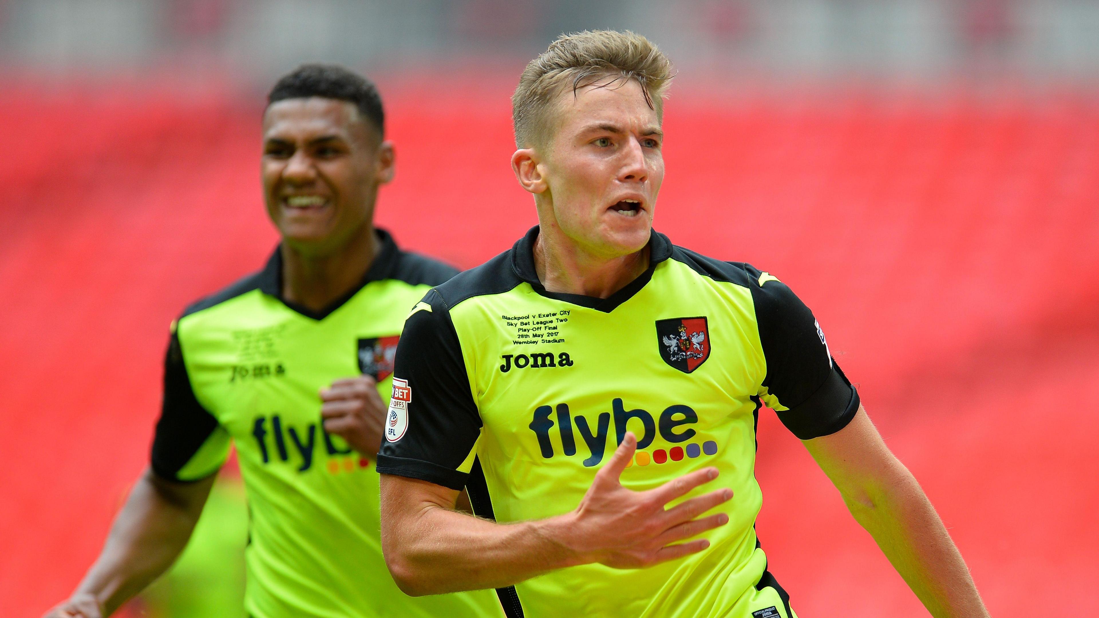 David Wheeler of Exeter City celebrates scoring in the League Two play-off final in 2017 with team-mate Ollie Watkins in the background