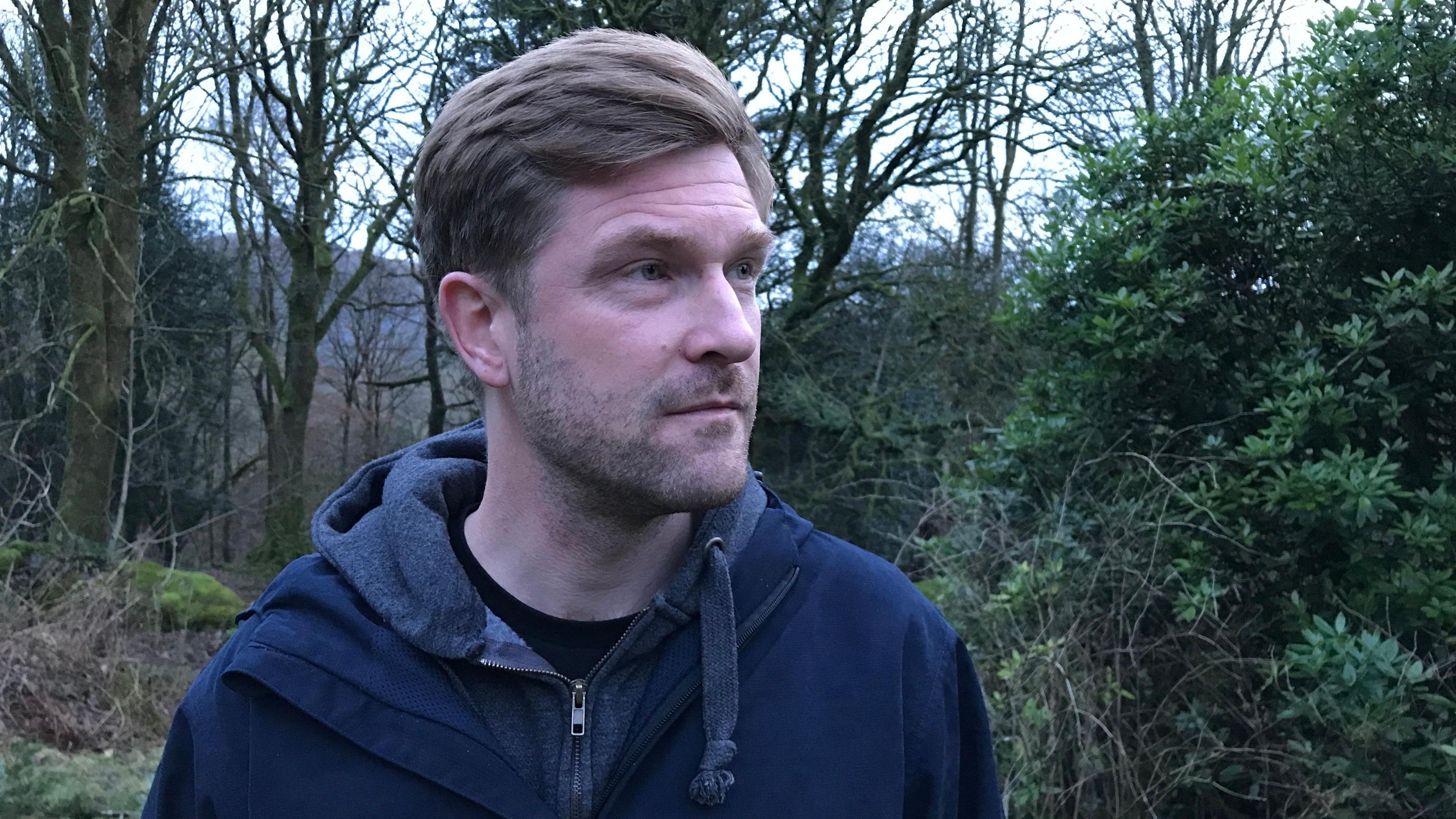 Elterwater bar owner Joe Nichols standing beside trees in Langdale