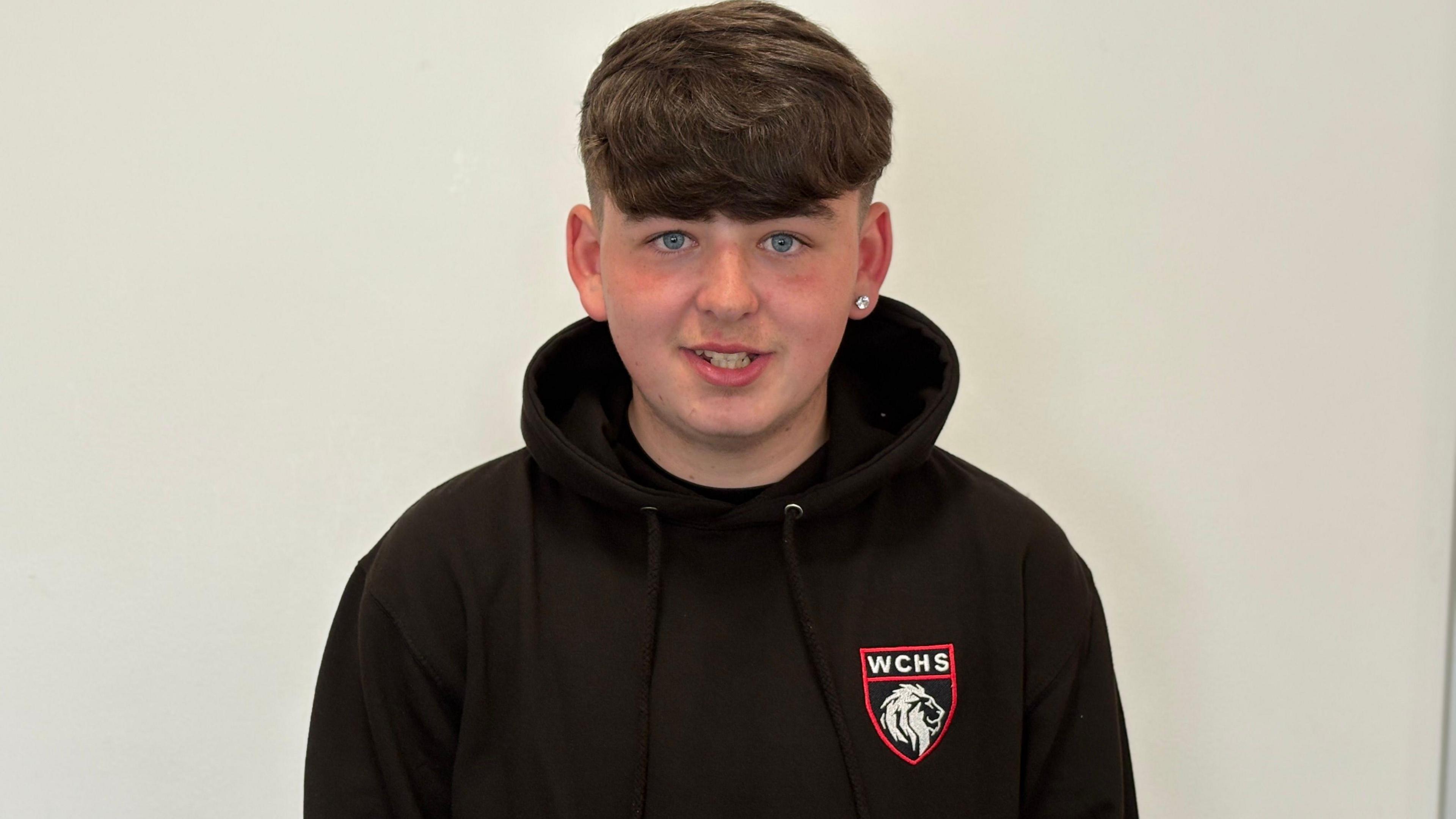 A photo of a pupil wearing a black West calder hoodie