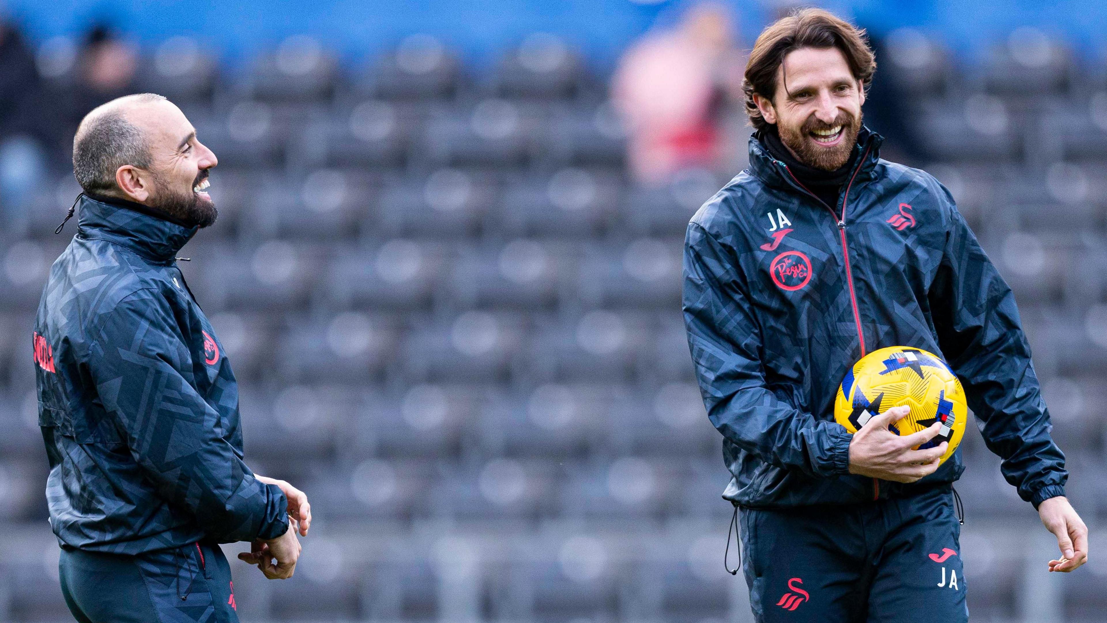Leon Britton and Joe Allen smiling during a Swansea warm-up