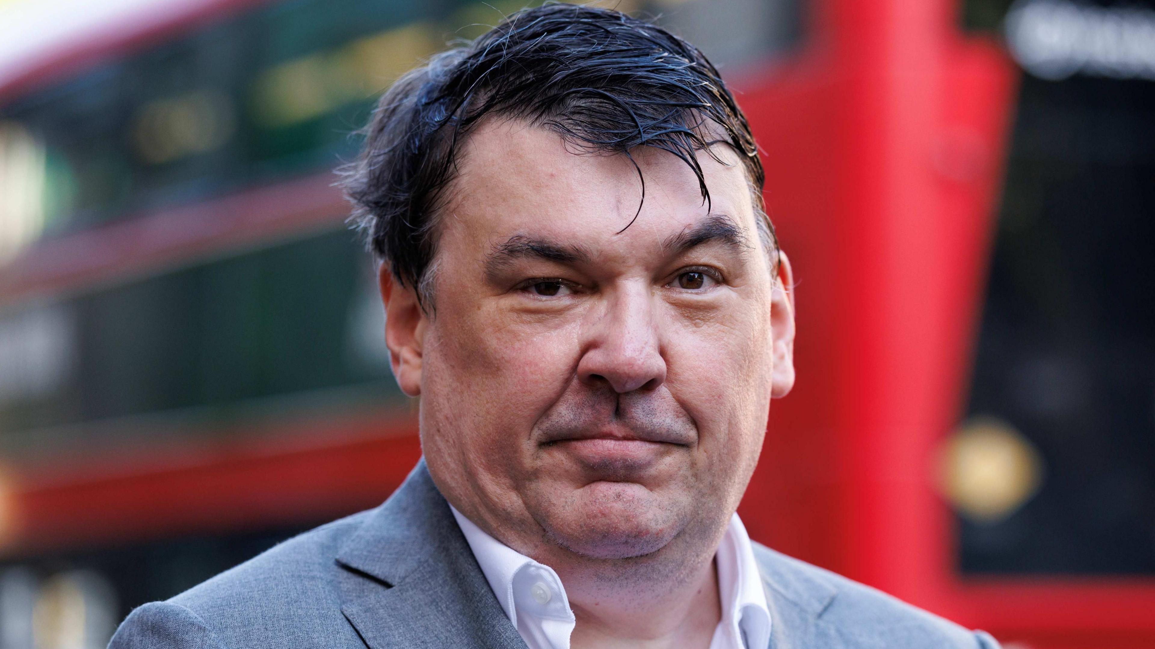 Graham Linehan in a grey jacket and white shirt