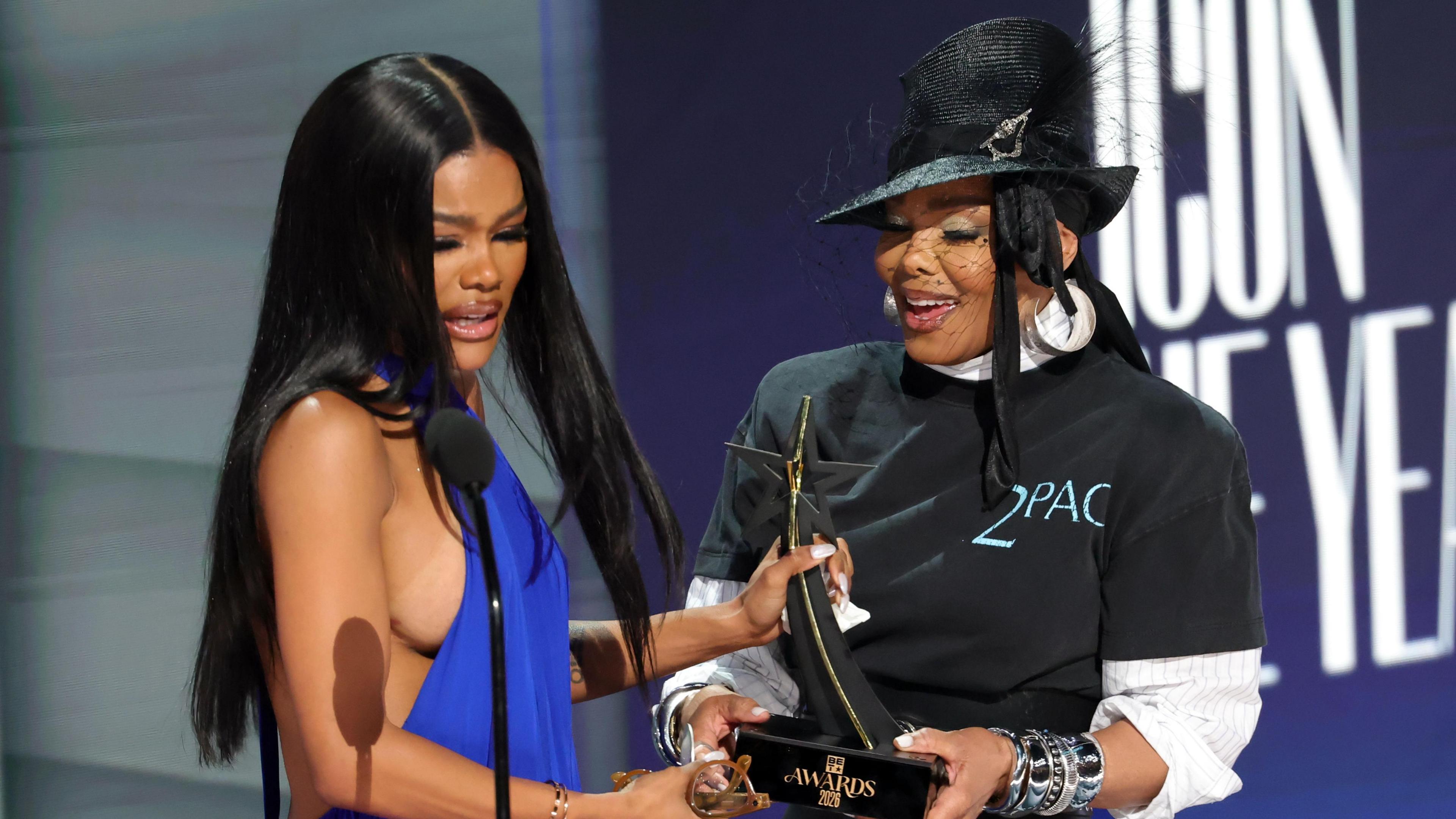 Janet Jackson passing a trophy to Teyana Taylor
