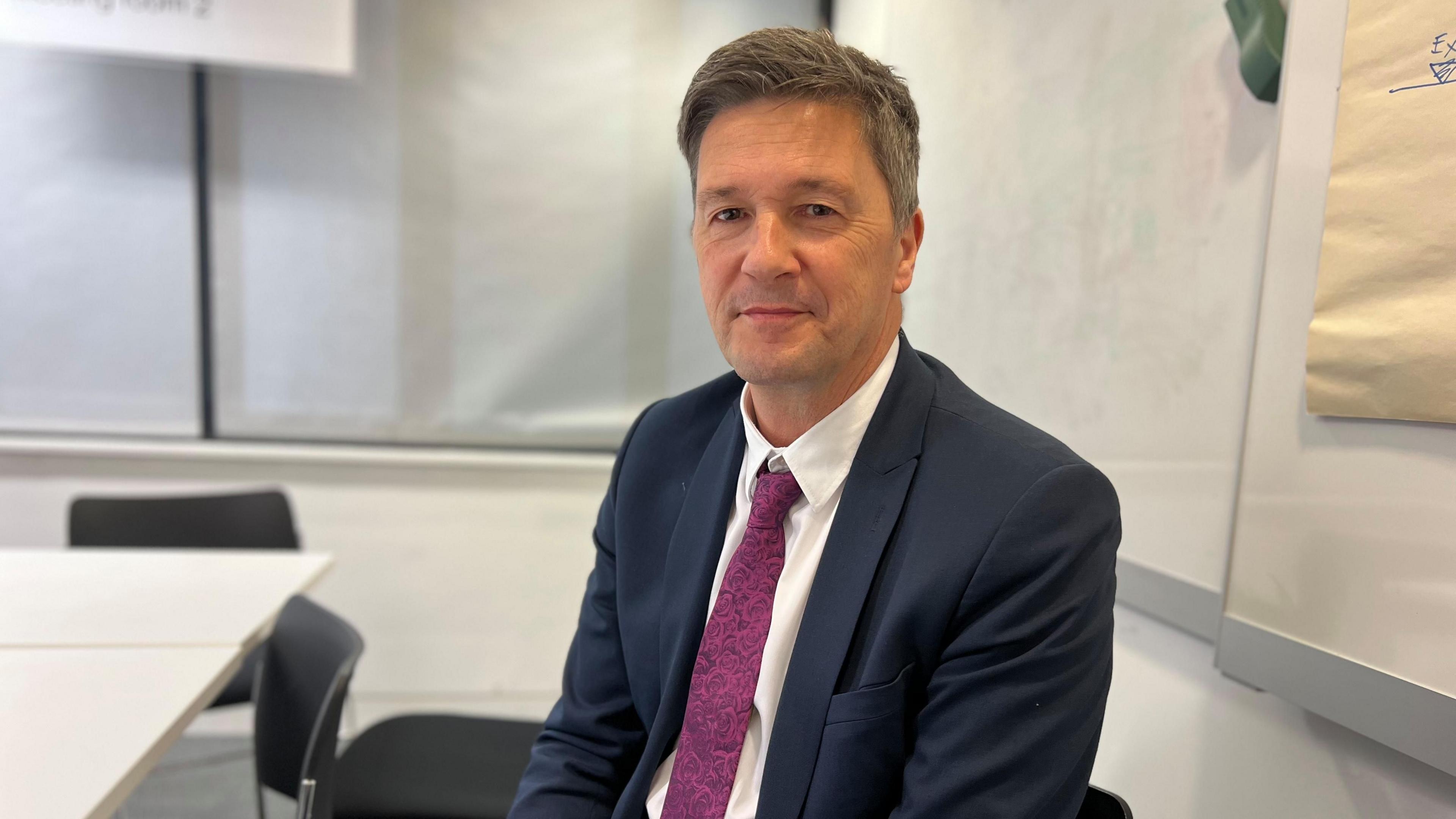 John Whitby sat in a meeting room