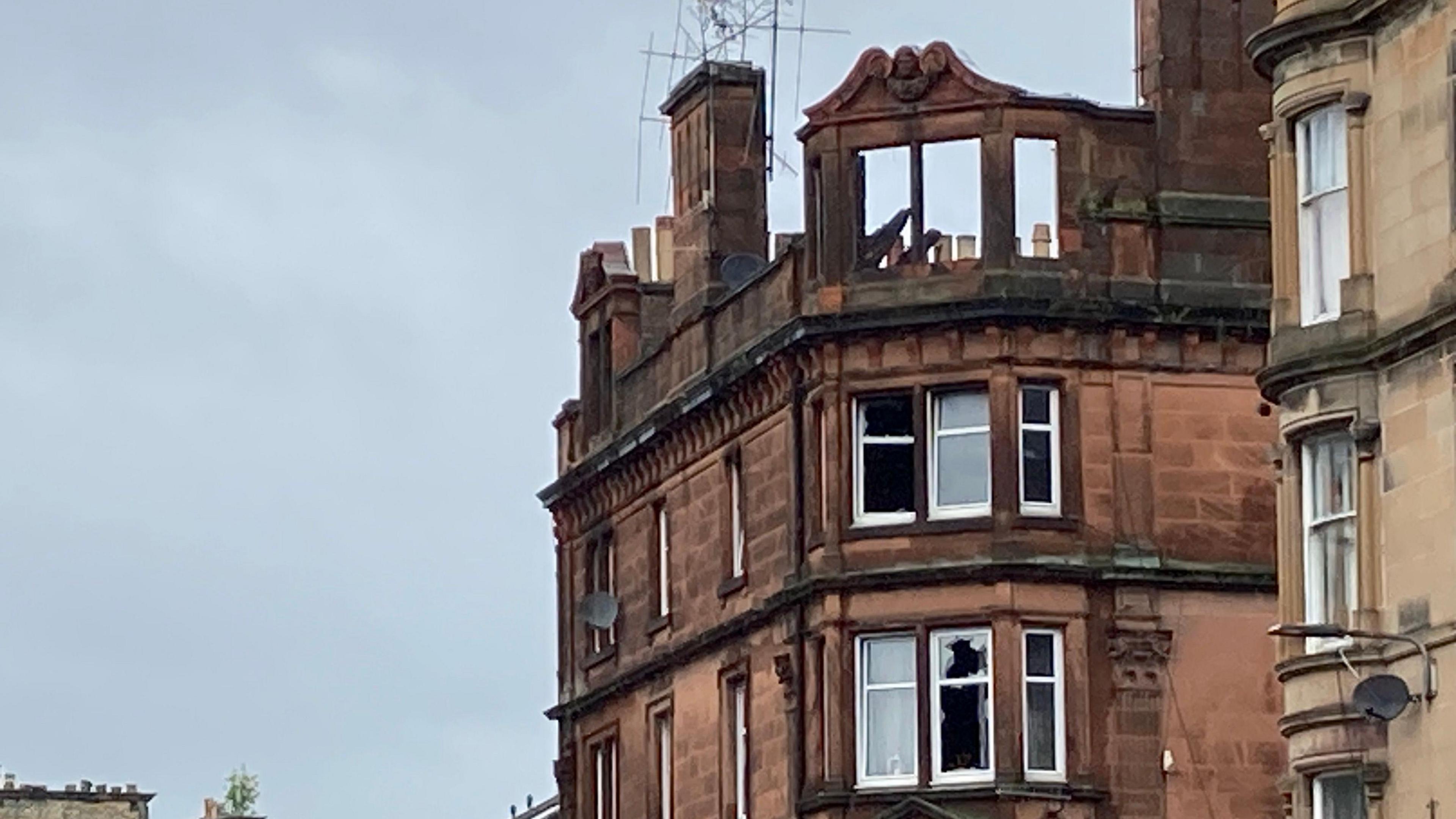 A tenement block in Perth which has been badly damaged by fire. the roof and upper windows have collapsed and several other windows are smashed.