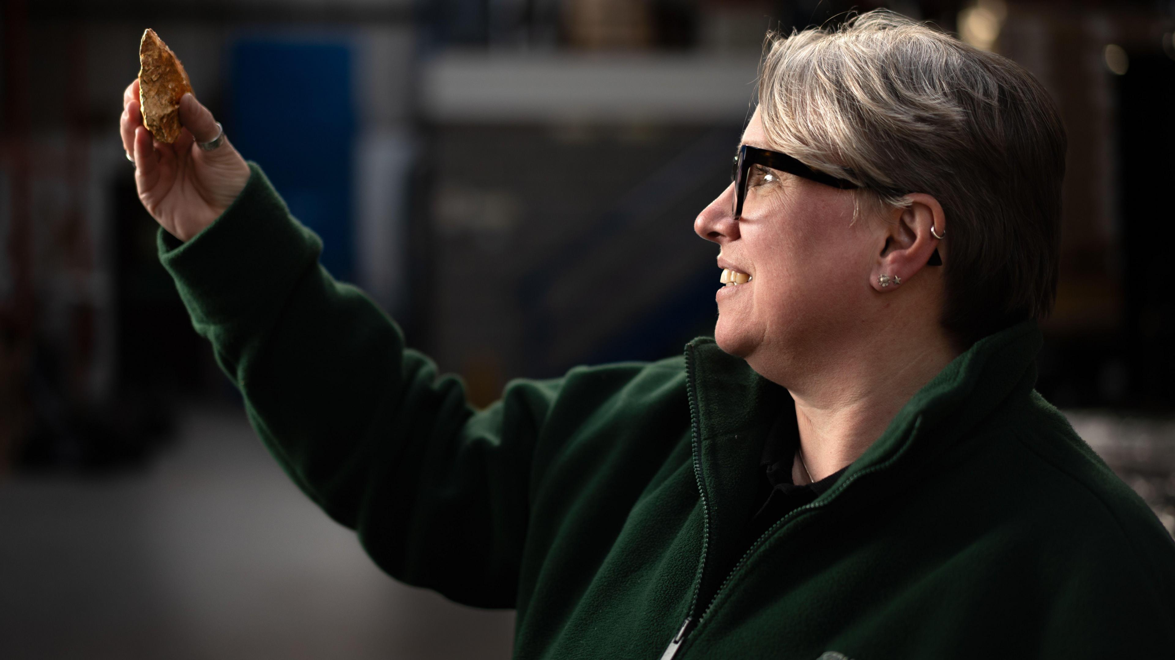 Dr Sara Machin, the finds lead for a consortium of archaeologists working on the post excavation archive holding a Paleolithic hand axe