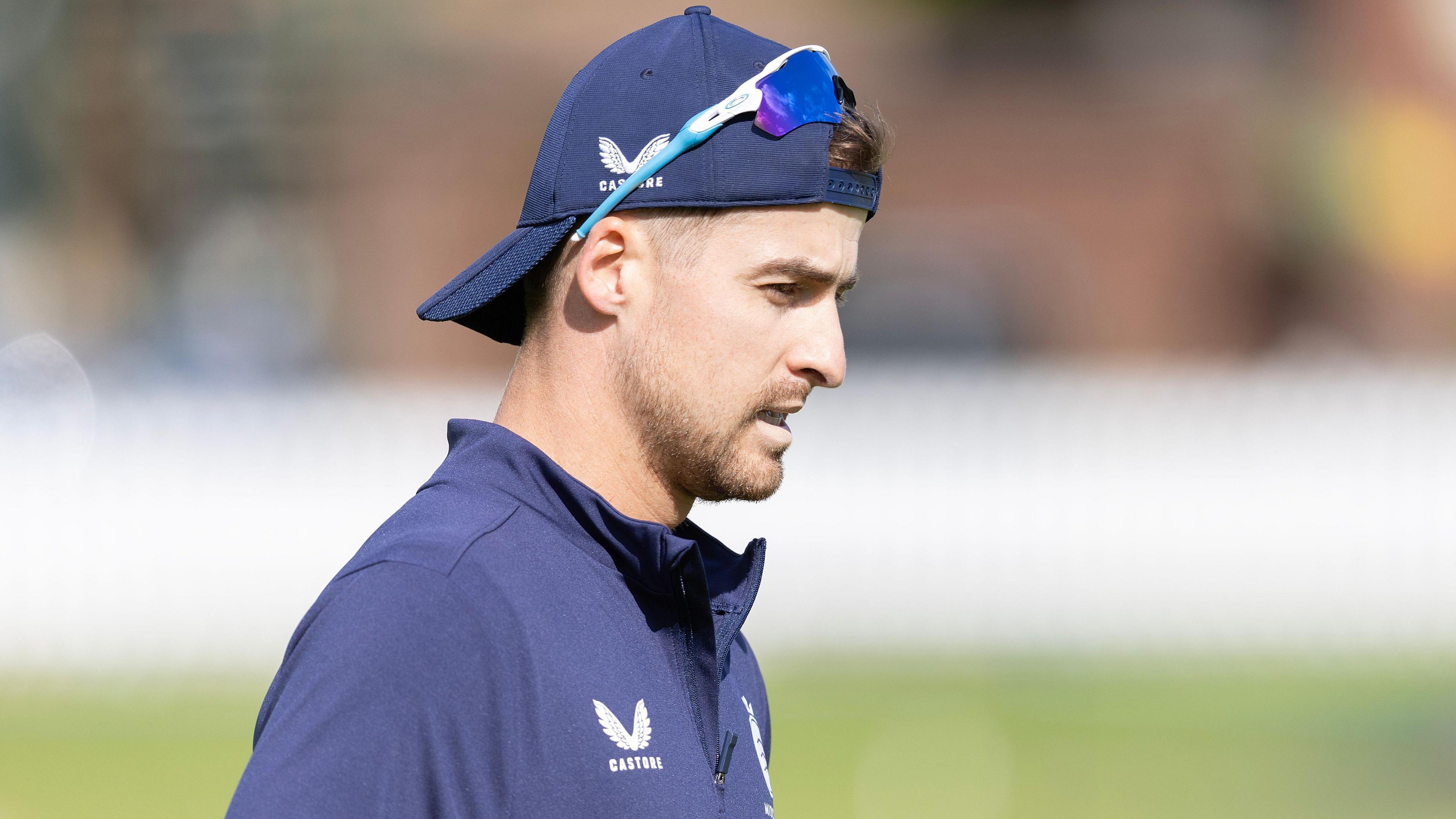 Leus du Plooy trains for Middlesex, dressed in a blue training top, a backwards blue baseball cap and silver and blue sunglasses on his forehead