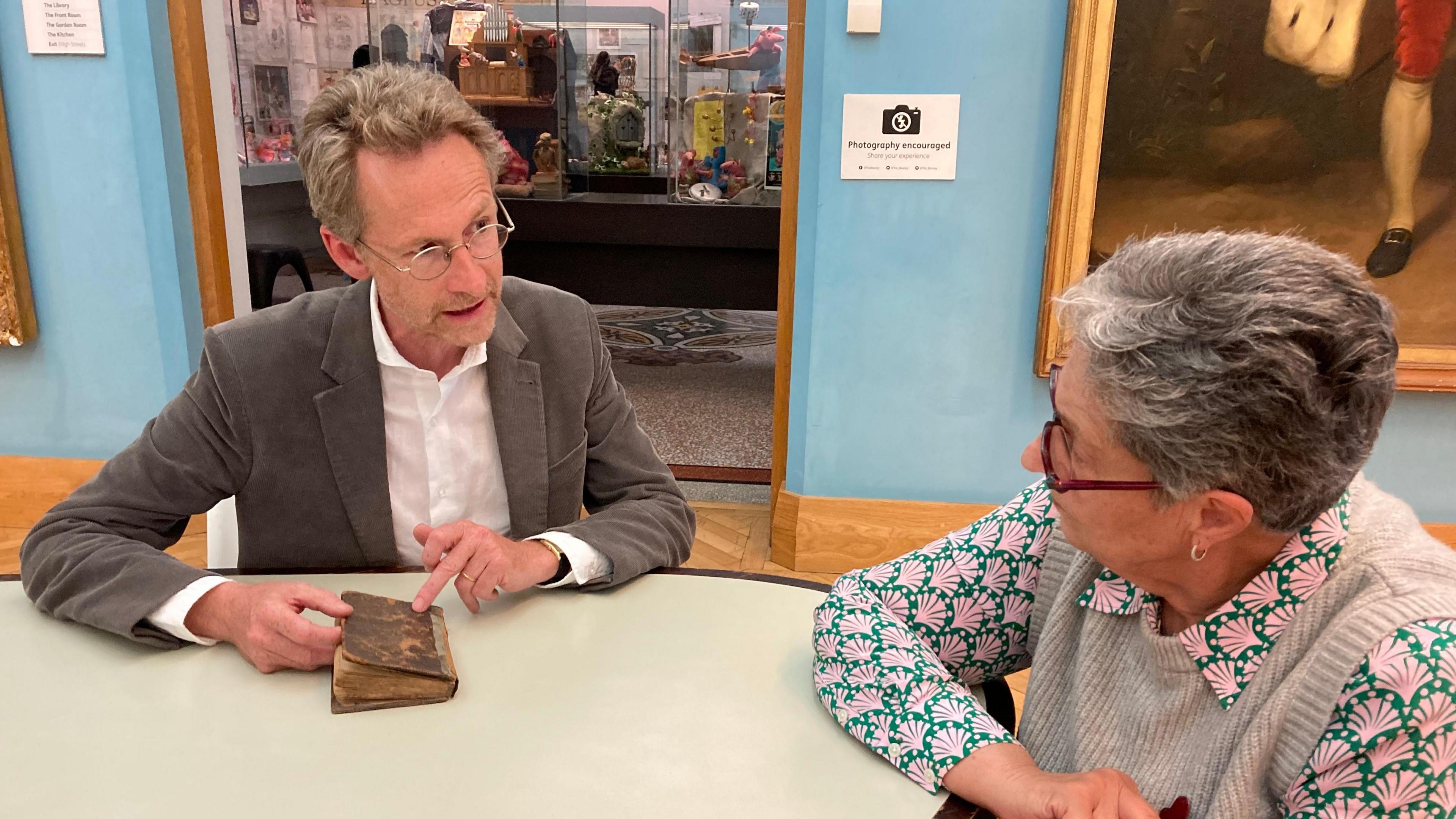 Antiques Roadshow specialist presenter Justin Croft discussing the book with Ms Astin