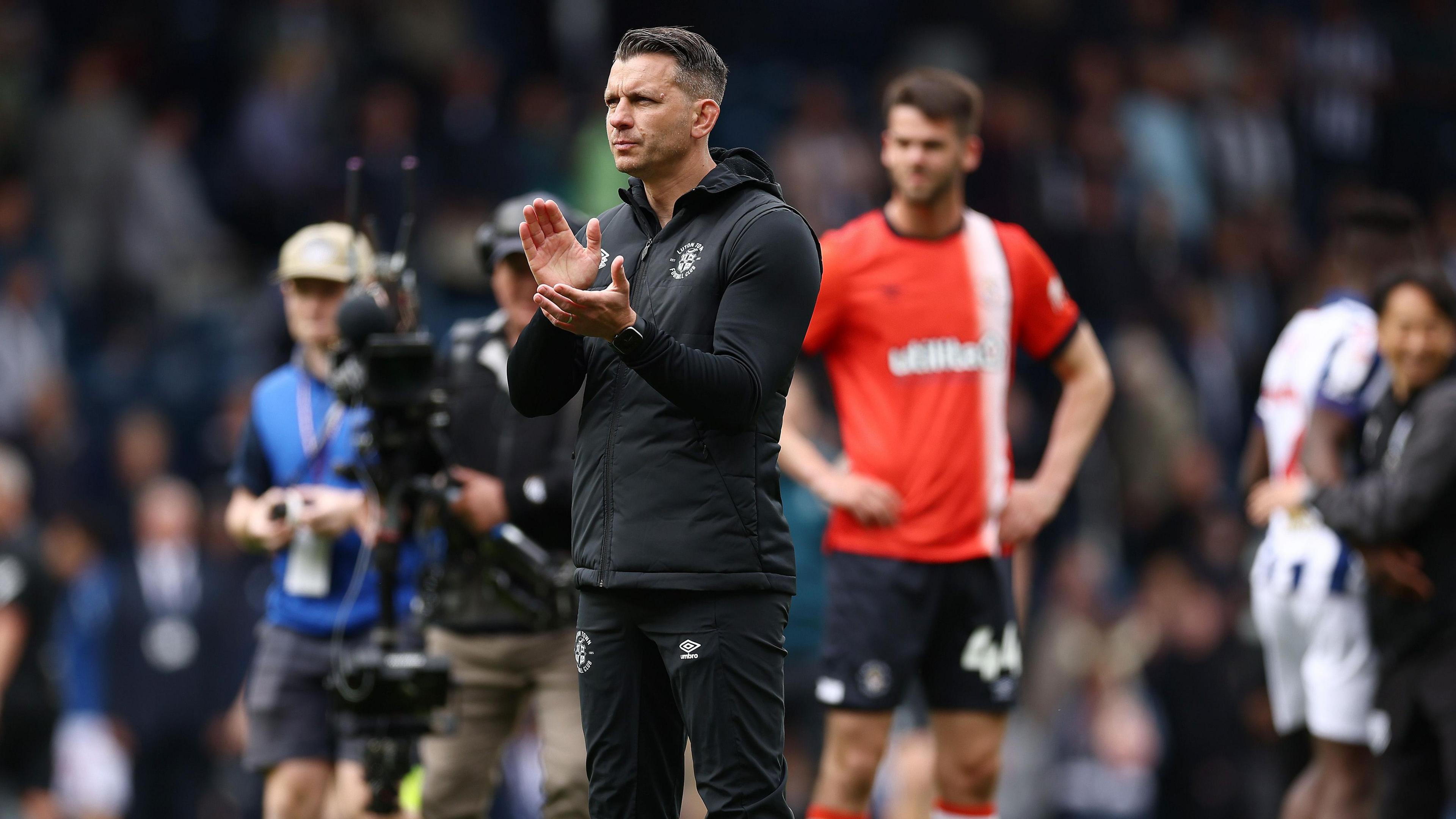 Luton Town manager Matt Bloomfield applauds travelling fans at full time
