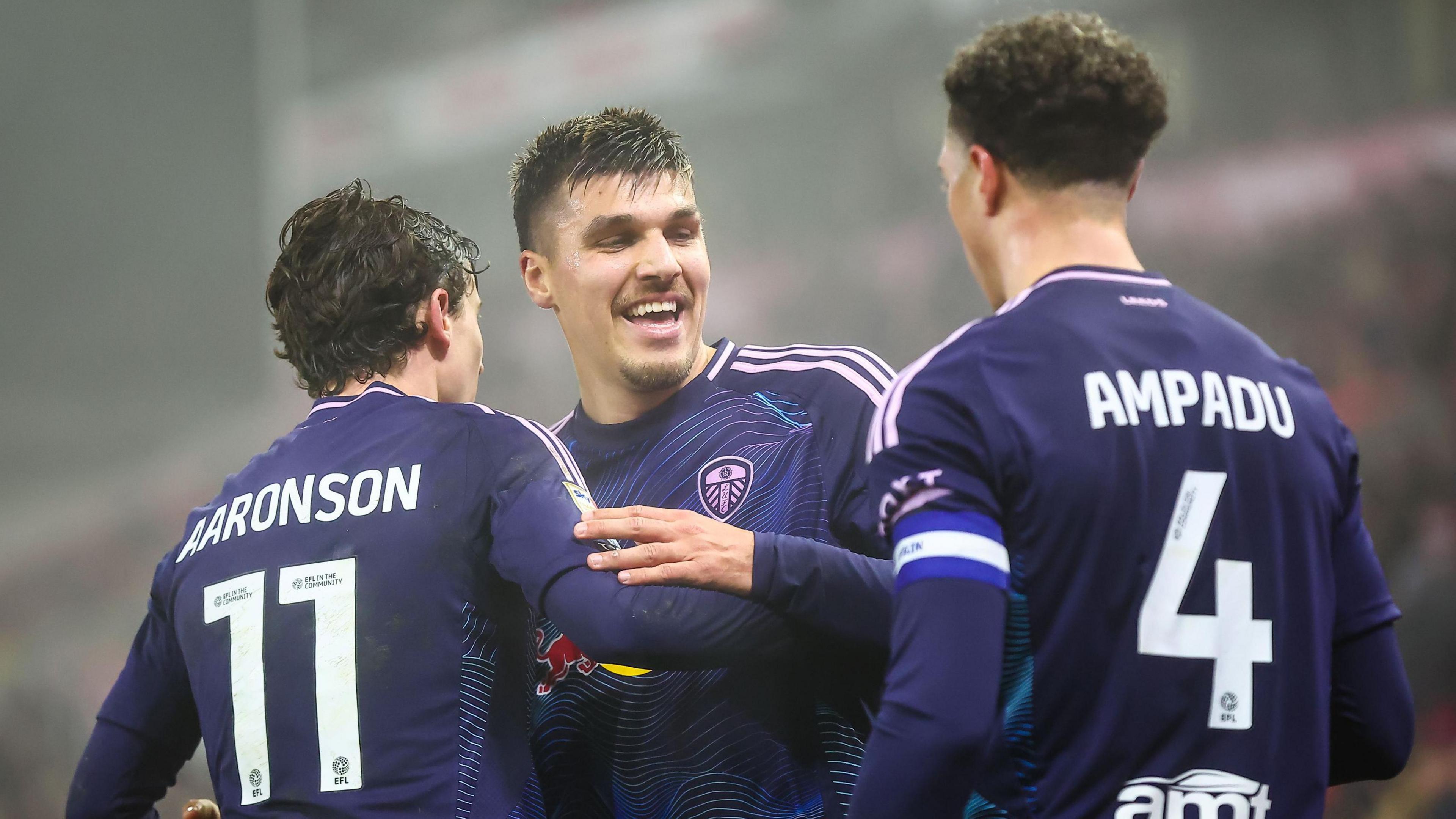 Leeds goal taker Joel Piroe celebrates at Stoke with one of his goal makers Ethan Ampadu