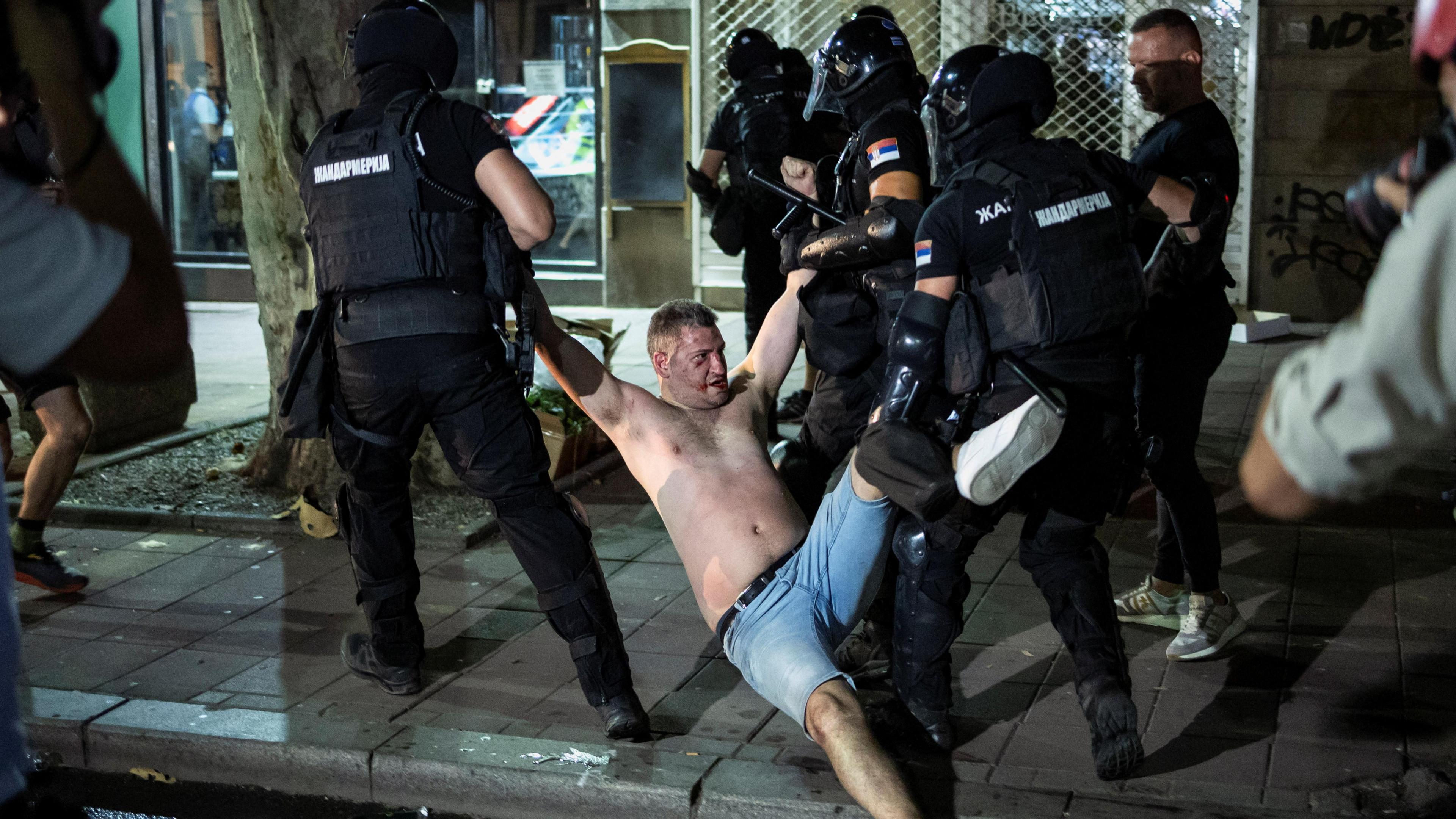 Law enforcement officers detain a demonstrator in Belgrade