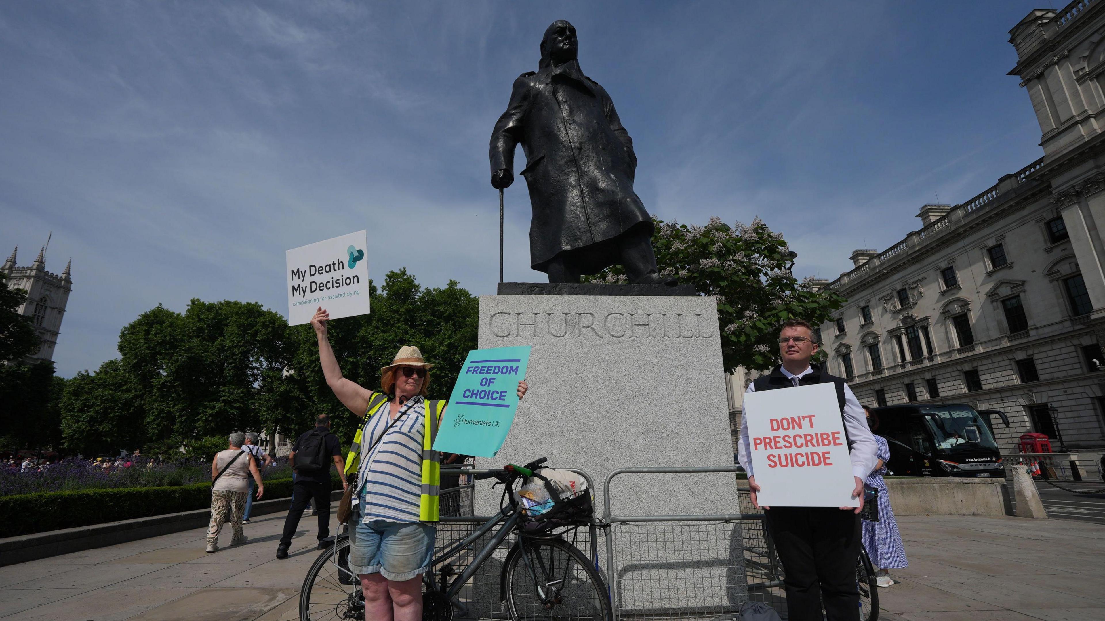 Campaigners in support and opposition to the assisted dying bill gather under the statue of Winston Churchill, in London