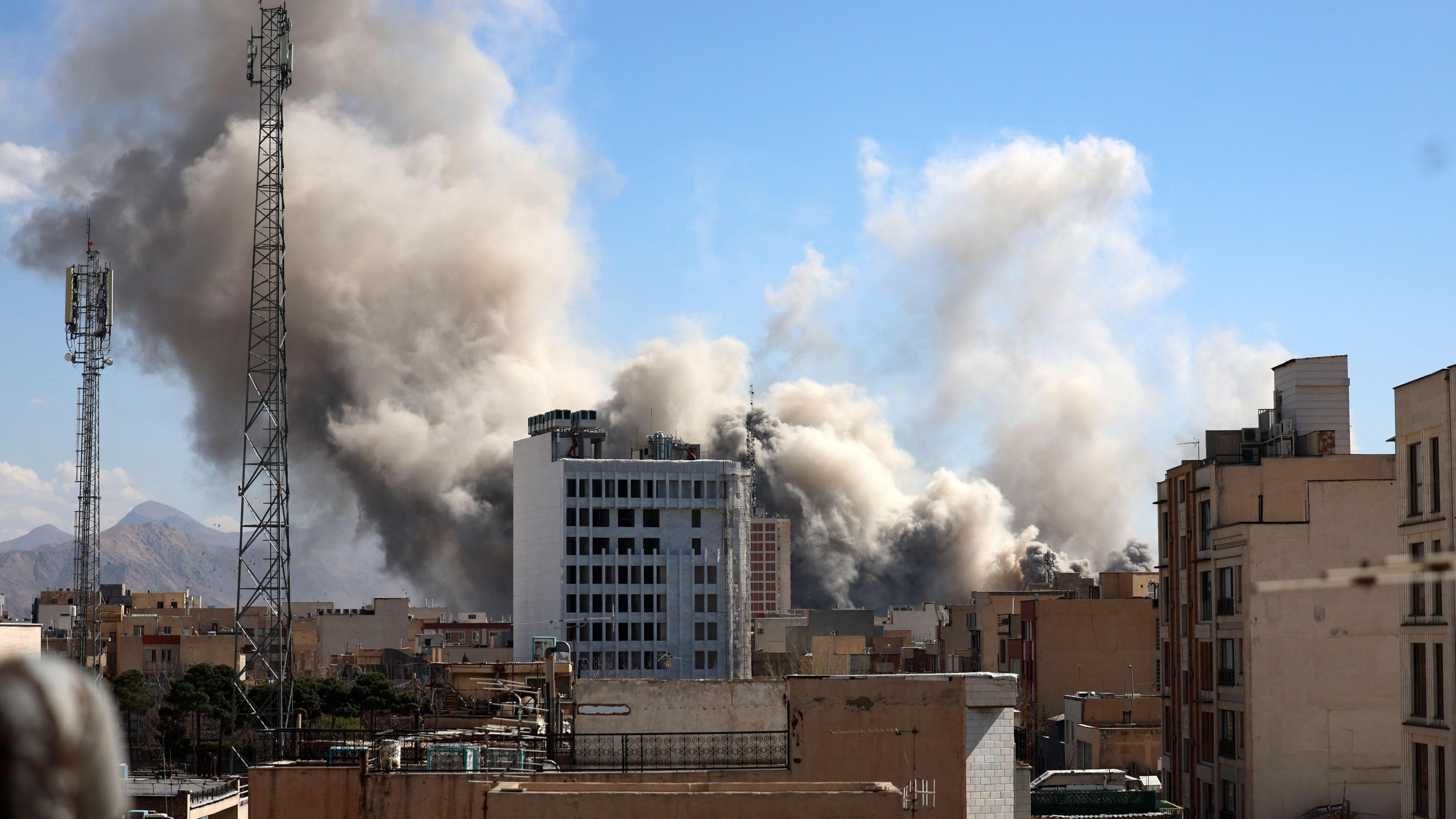 Smoke billowing from behind a building in Iran