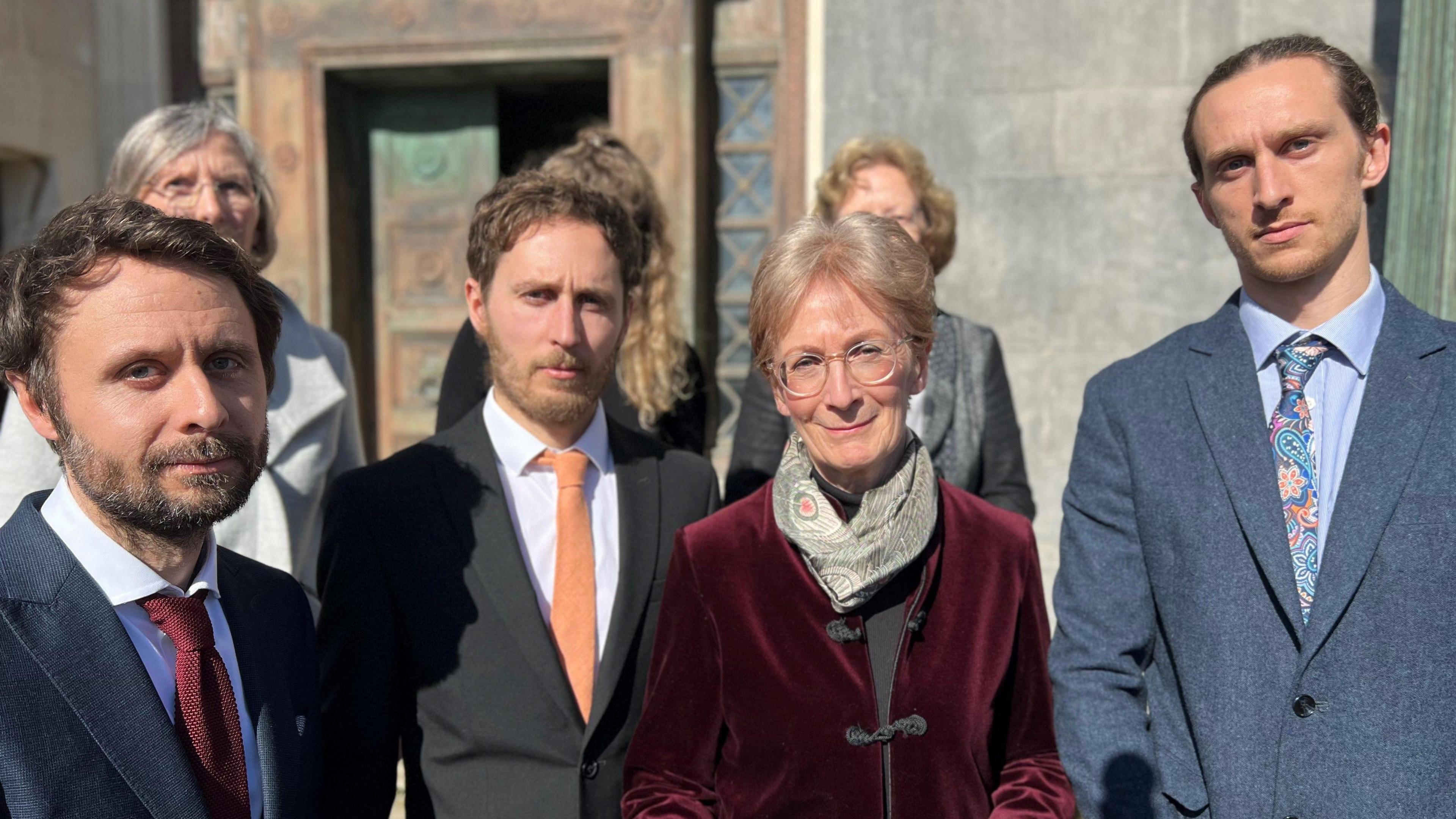 Jane Harrison and her sons standing on the court steps 