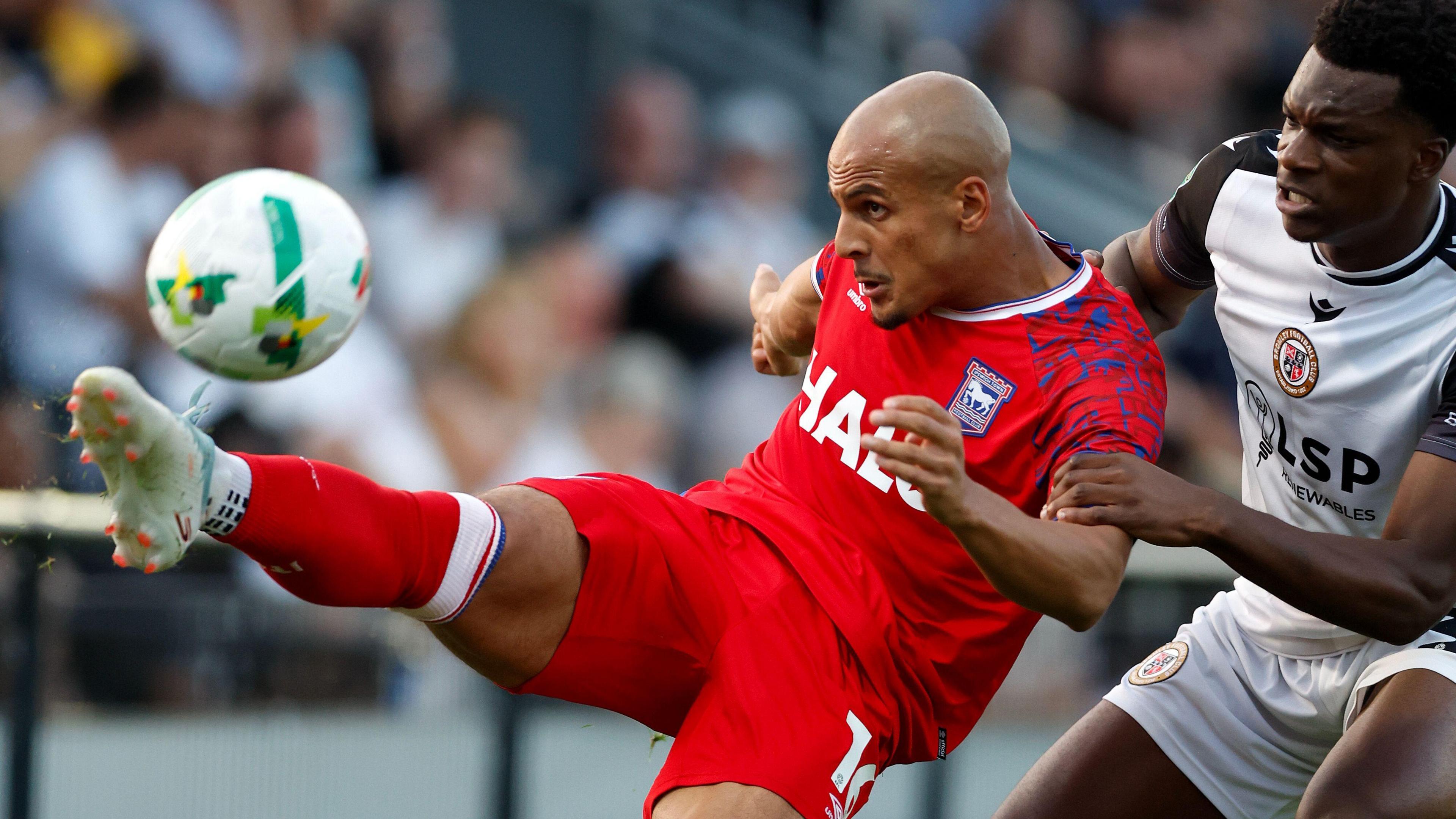 Ali Al-Hamadi hooks the ball away under pressure from a Bromley player during the Carabao Cup tie between the sides