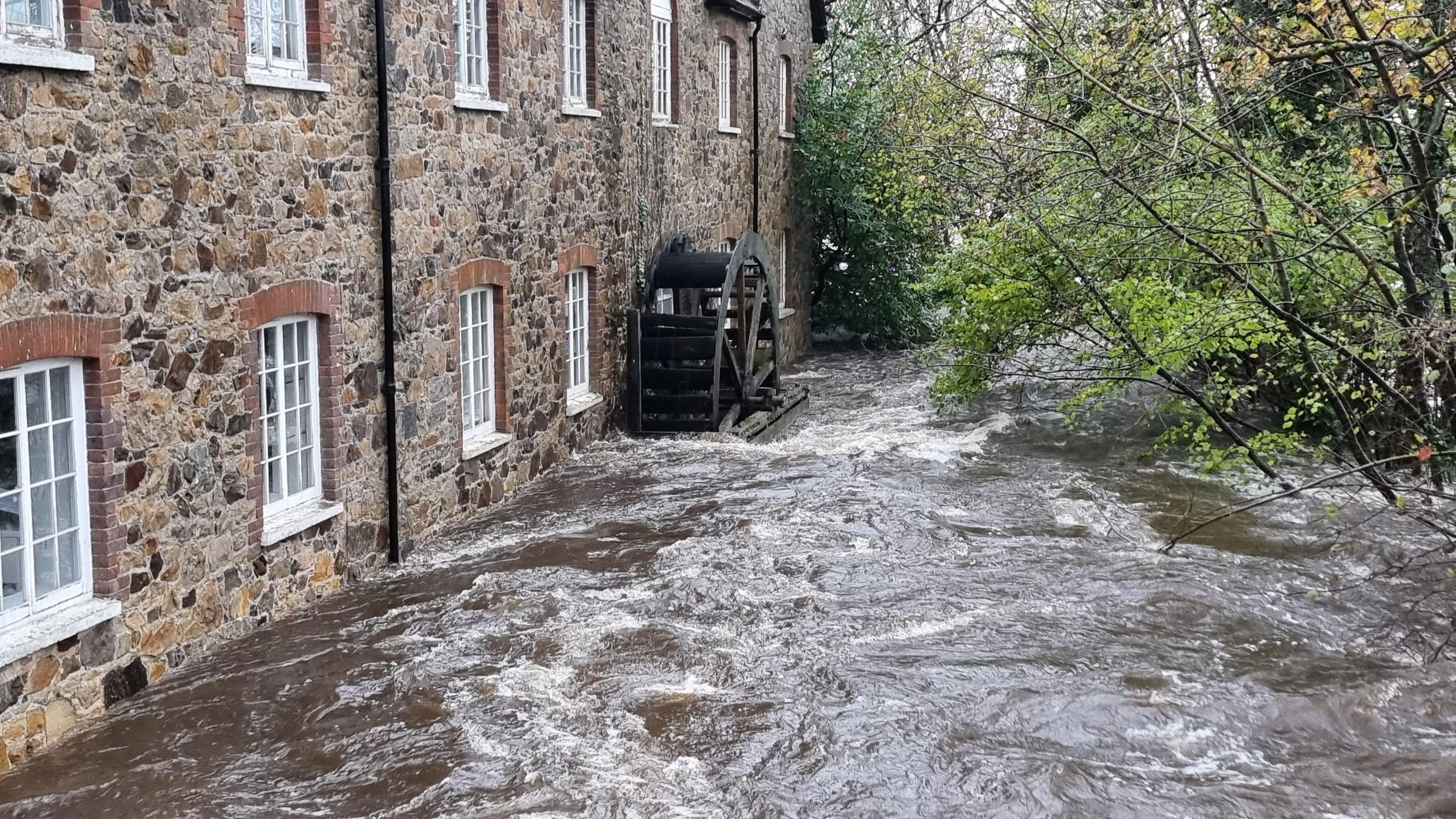 The water from a nearby river has risen just below a house's window sills in Bovey Tracey