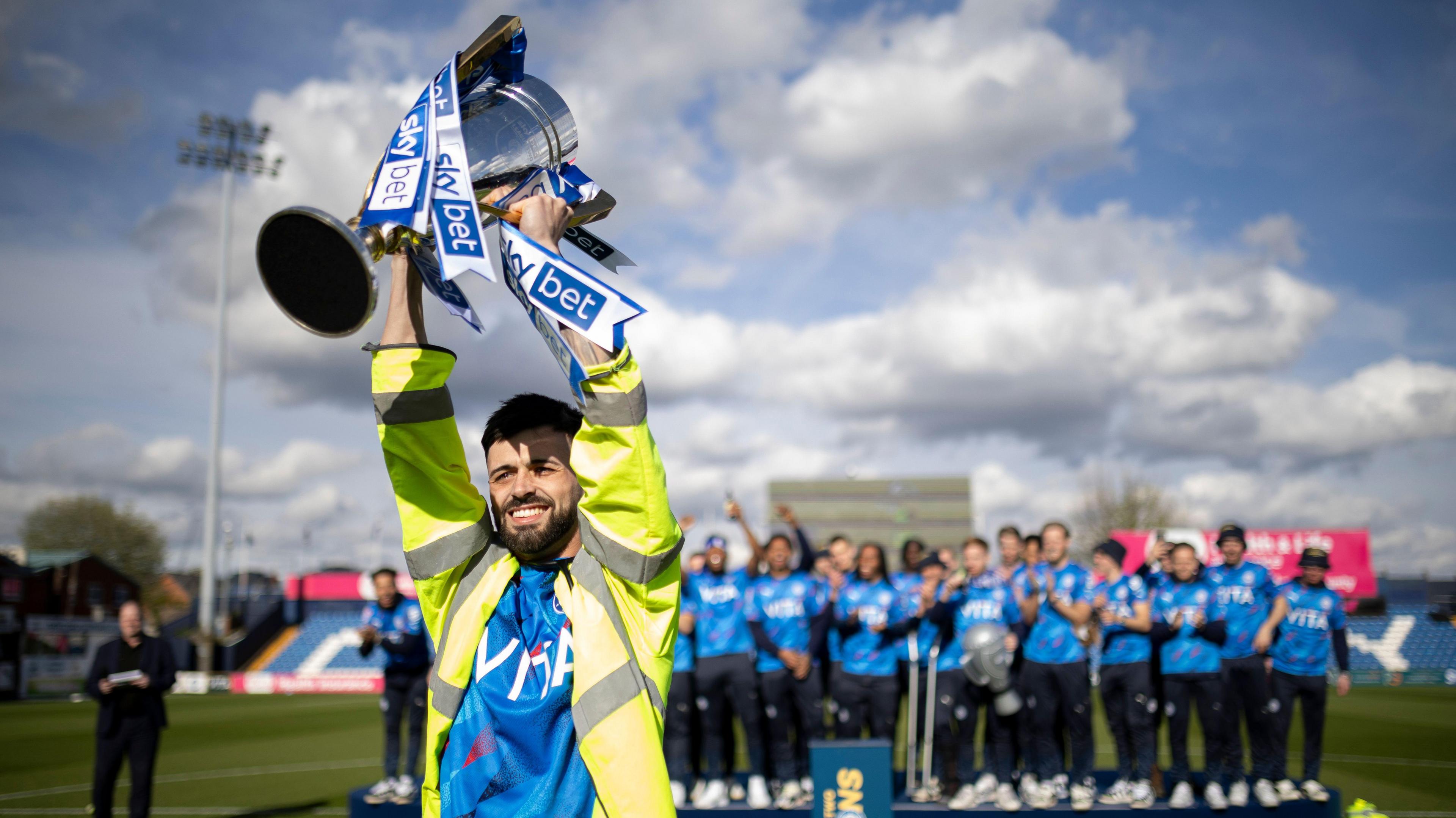 Macauley Southam-Hales lifts the League Two champions trophy