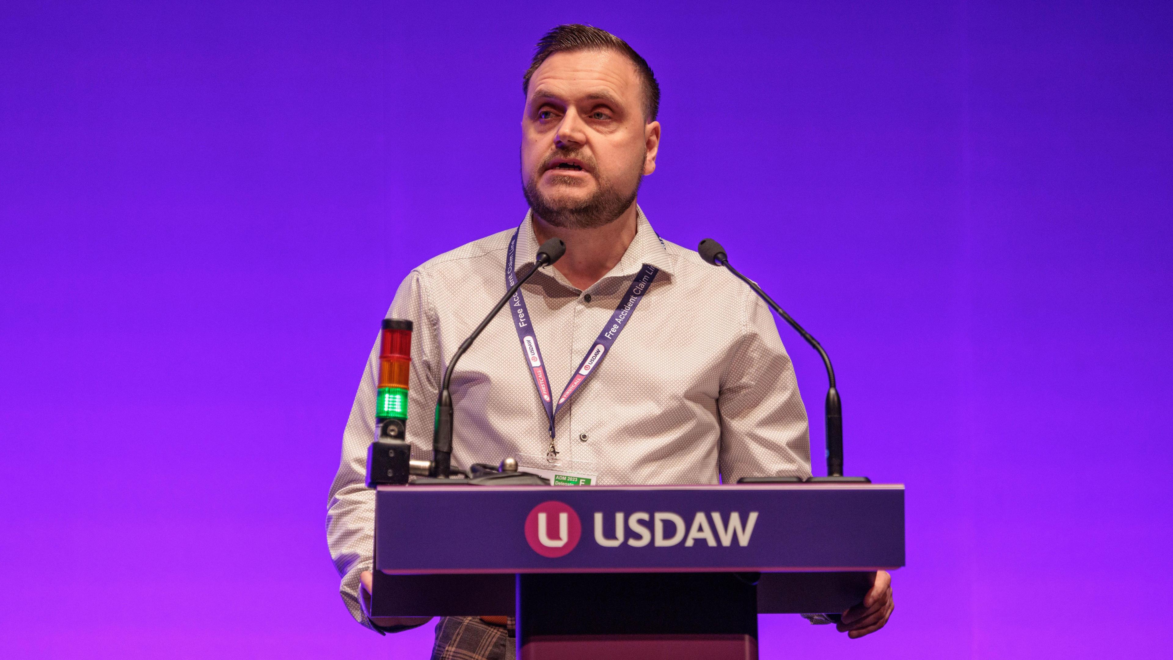 Retail worker Danny Hook speaking at an Usdaw podium